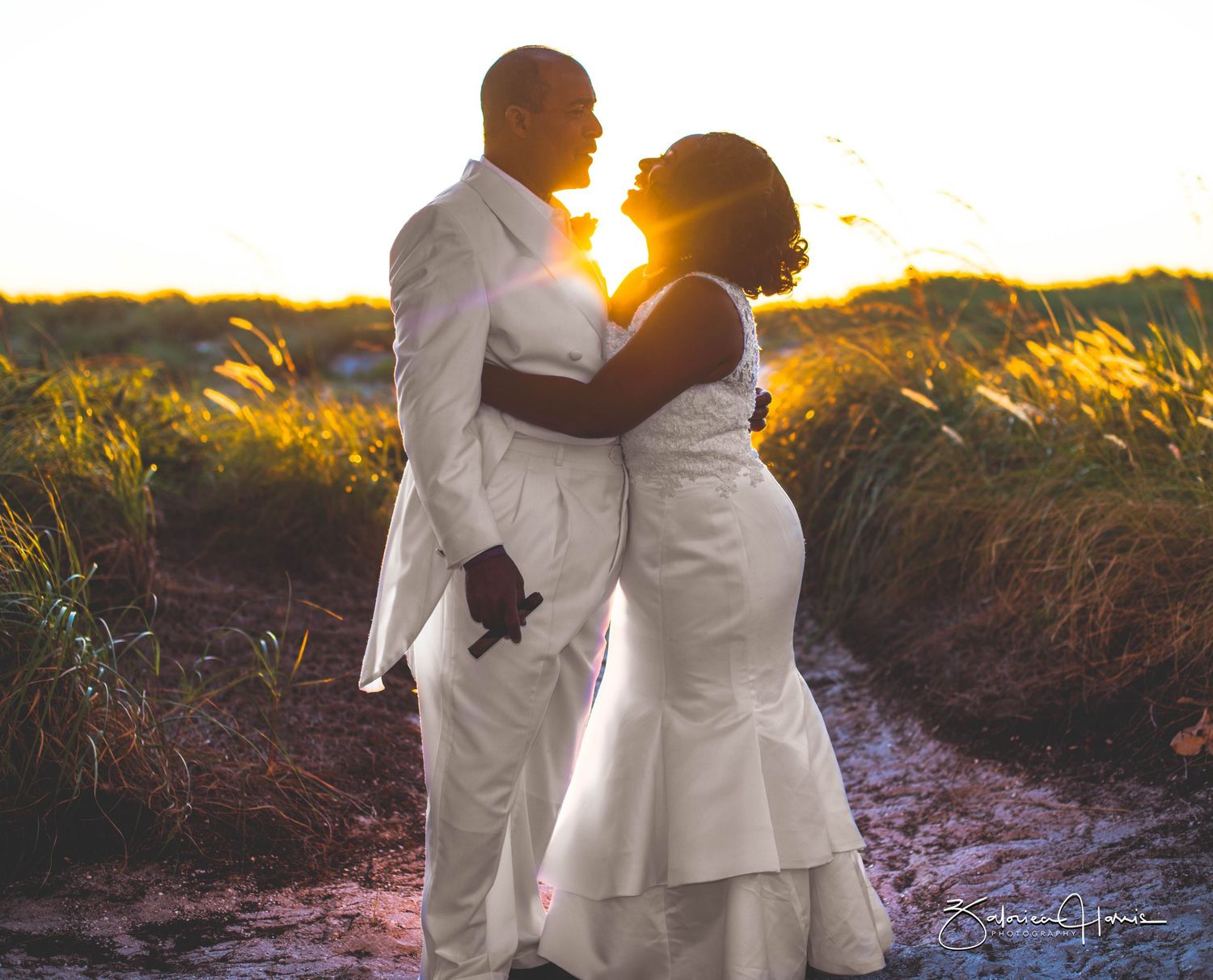 Romantic sunset photoshoot of a couple in white attire embracing on a beach in Clearwater beach Florida.
