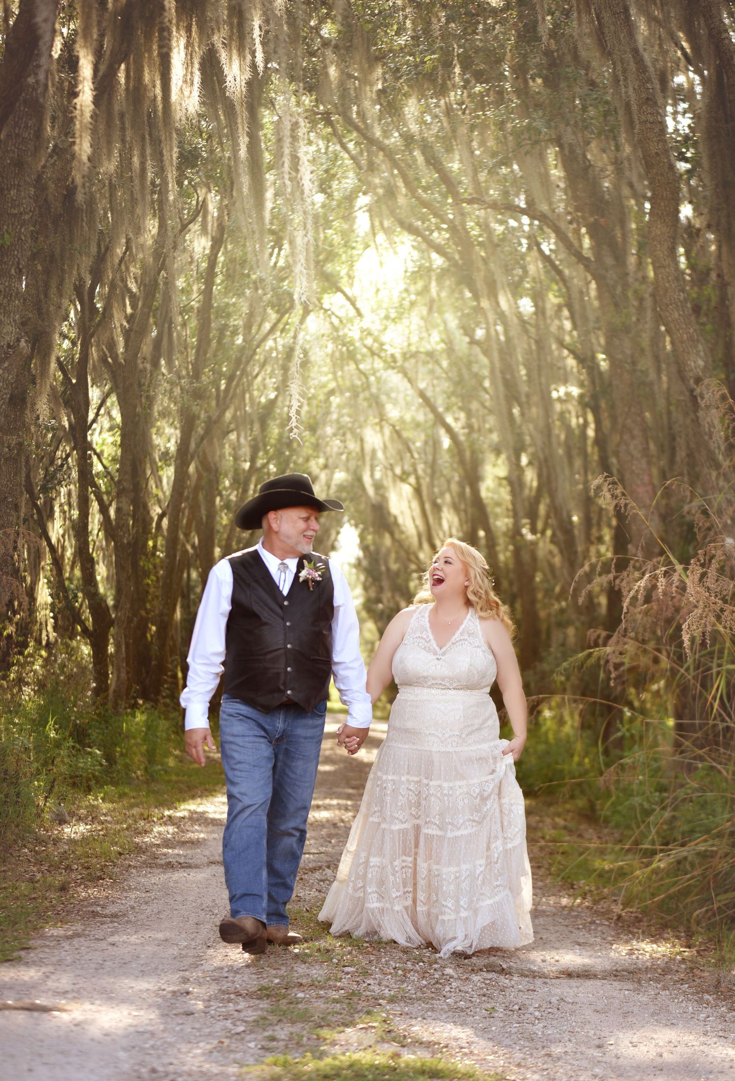 Rustic woodland wedding photos with sunlight streaming through Spanish moss trees.