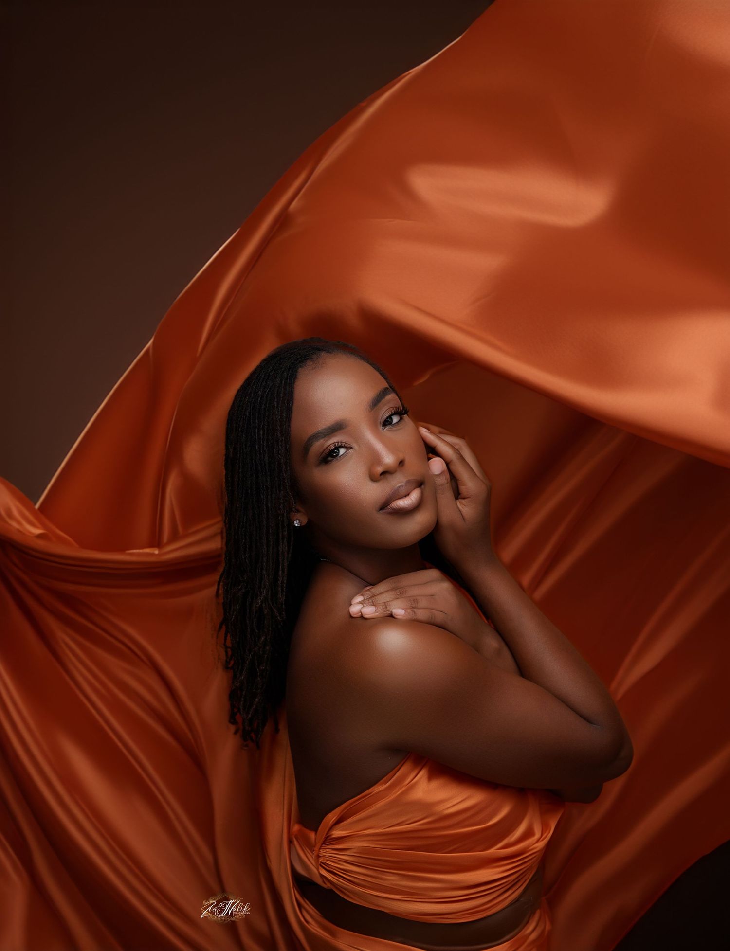 Artistic portrait series in copper-toned fabric with dramatic lighting and poses in Saint Petersburg Florida.