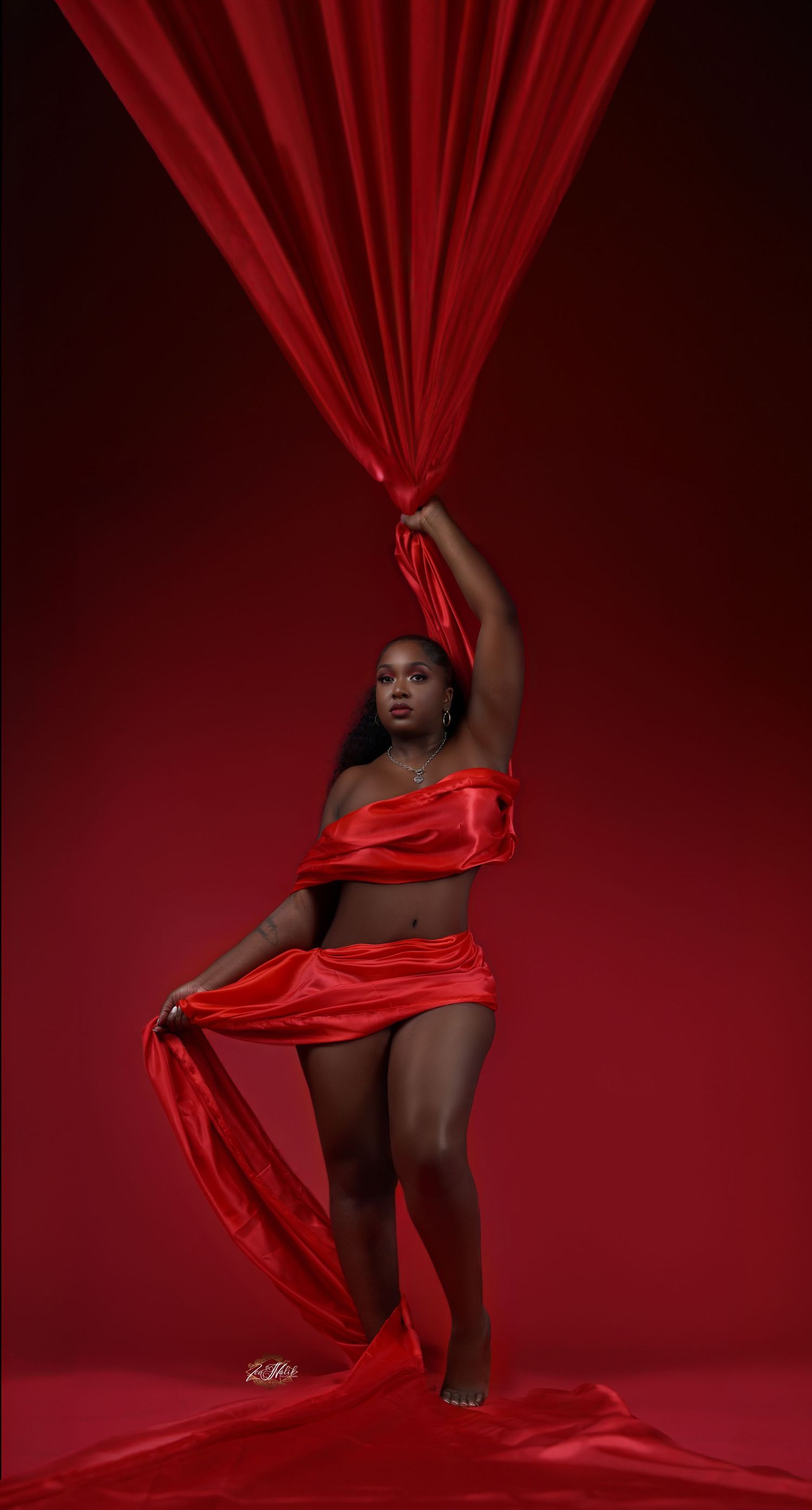 Dynamic photo series with flowing red fabric against deep crimson background creating movement in Saint Petersburg Florida.