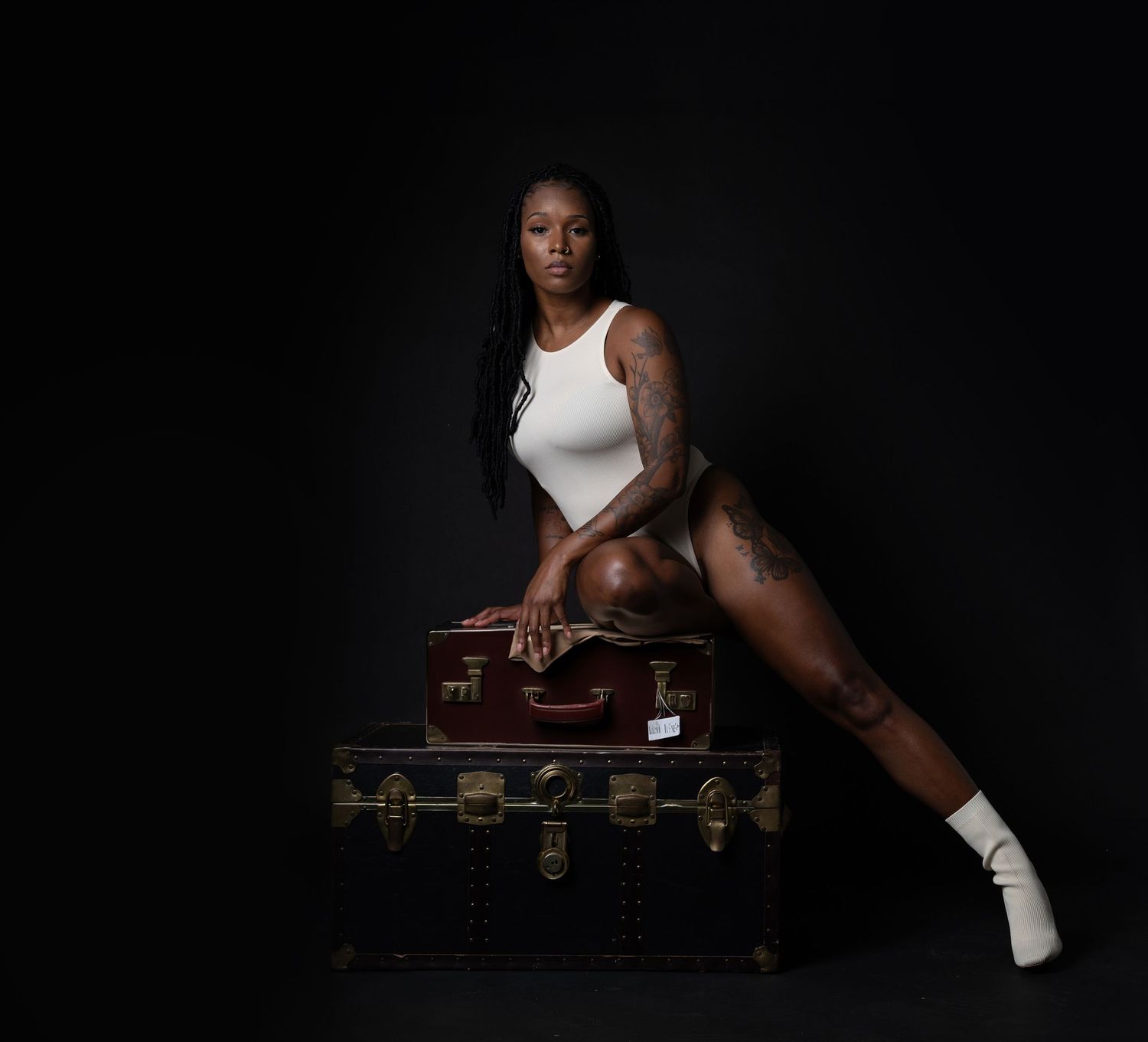 Minimalist black and white portrait series with athletic styling and vintage suitcase prop in Saint Petersburg Florida.