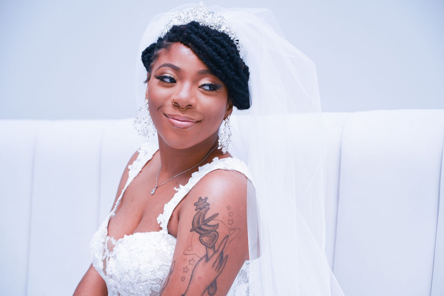 Wedding photography session with elegant white lace dress and veil details.