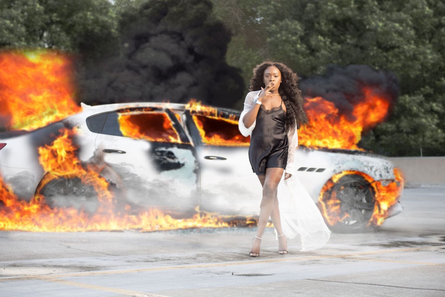 Dramatic scene of person walking away from burning car on road. In Tampa Florida.