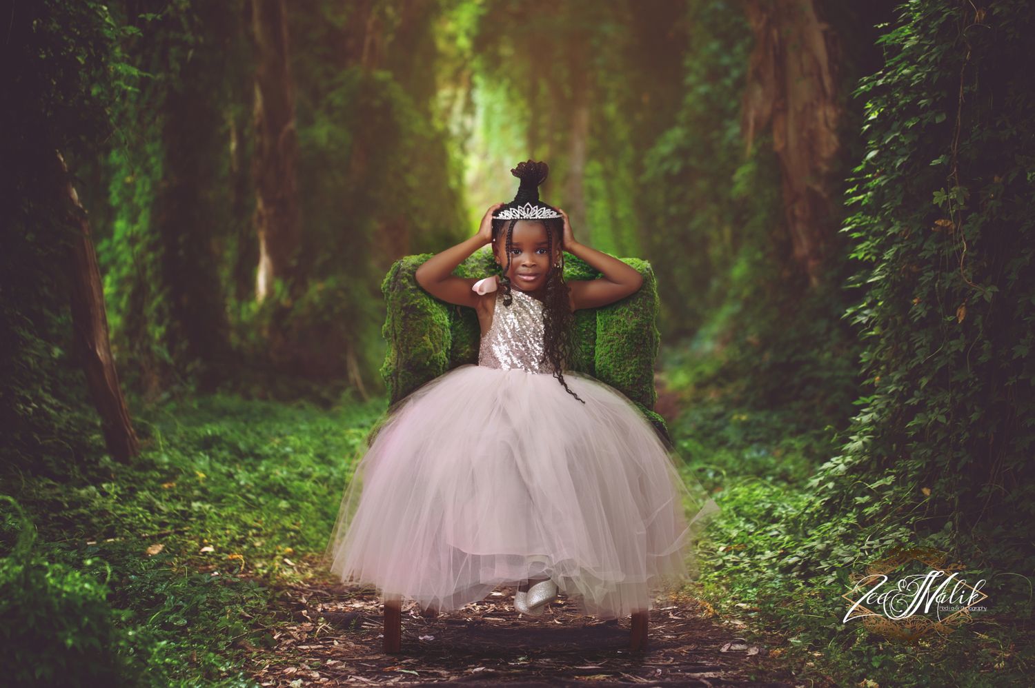 A bride in a flowing white gown walks through a misty green forest path creating a dreamy woodland scene.