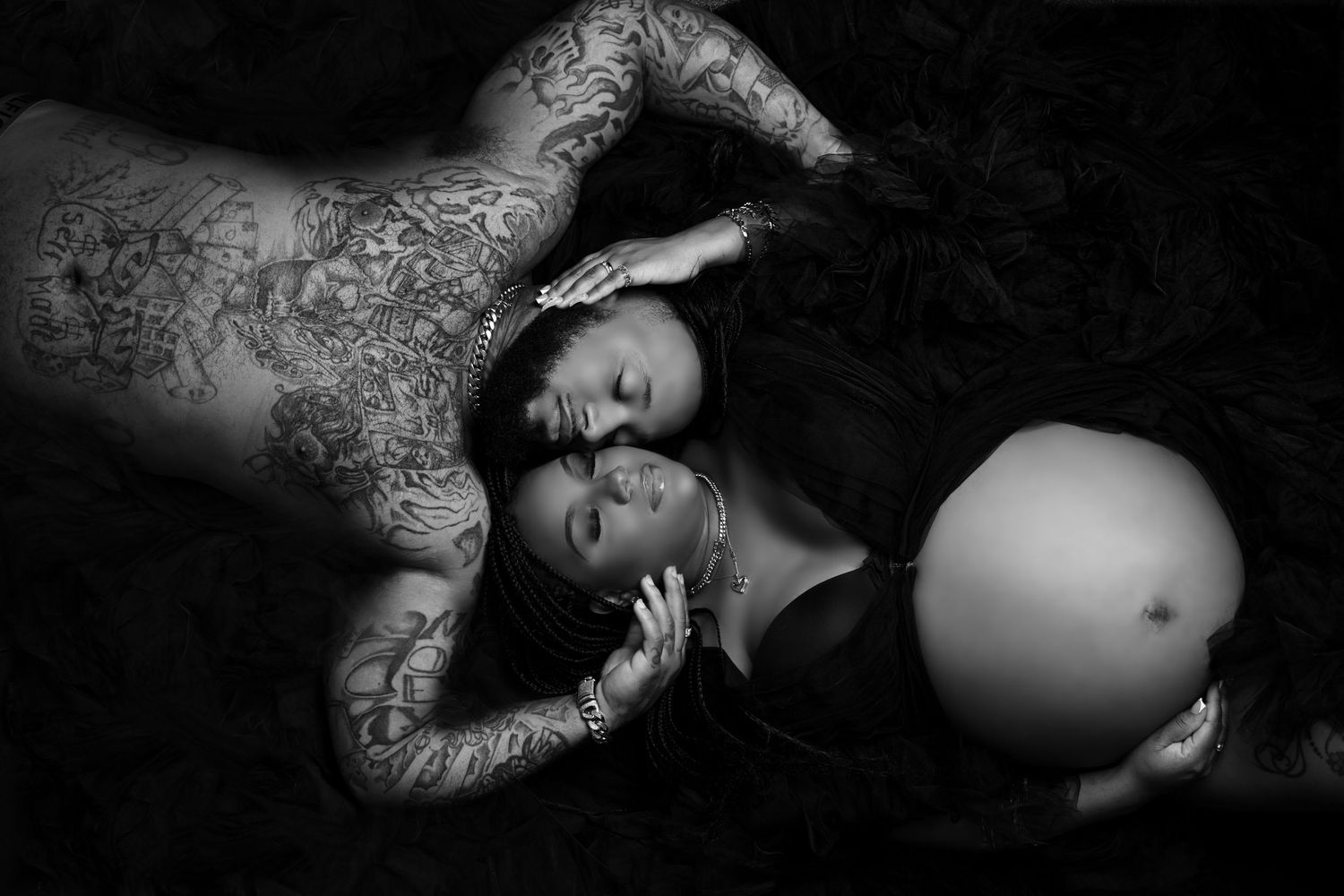 Black and white artistic maternity portraits with dramatic lighting and shadows.