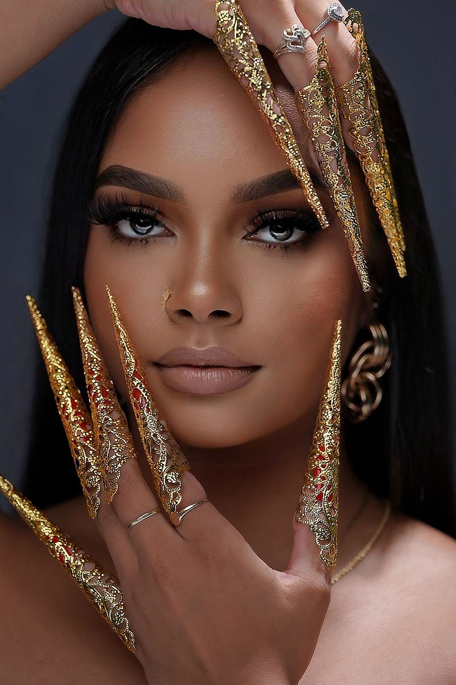 Beauty portrait featuring dramatic gold glitter nail extensions and flawless makeup in Saint Petersburg Florida.
