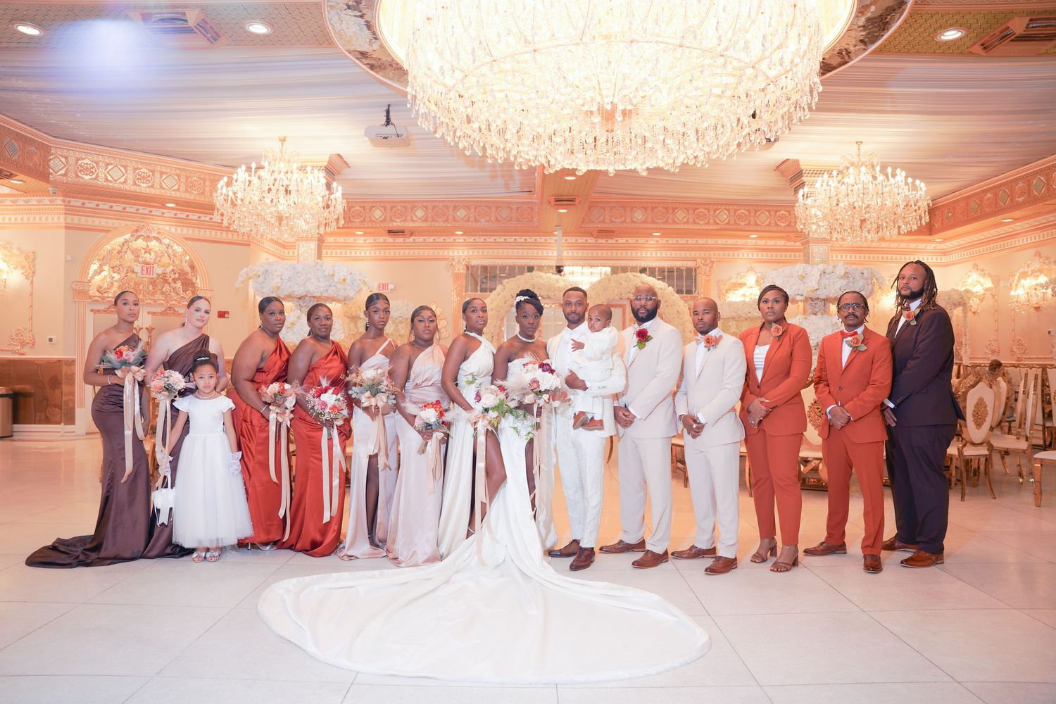 Elegant ballroom wedding reception with crystal chandeliers and formal table settings.