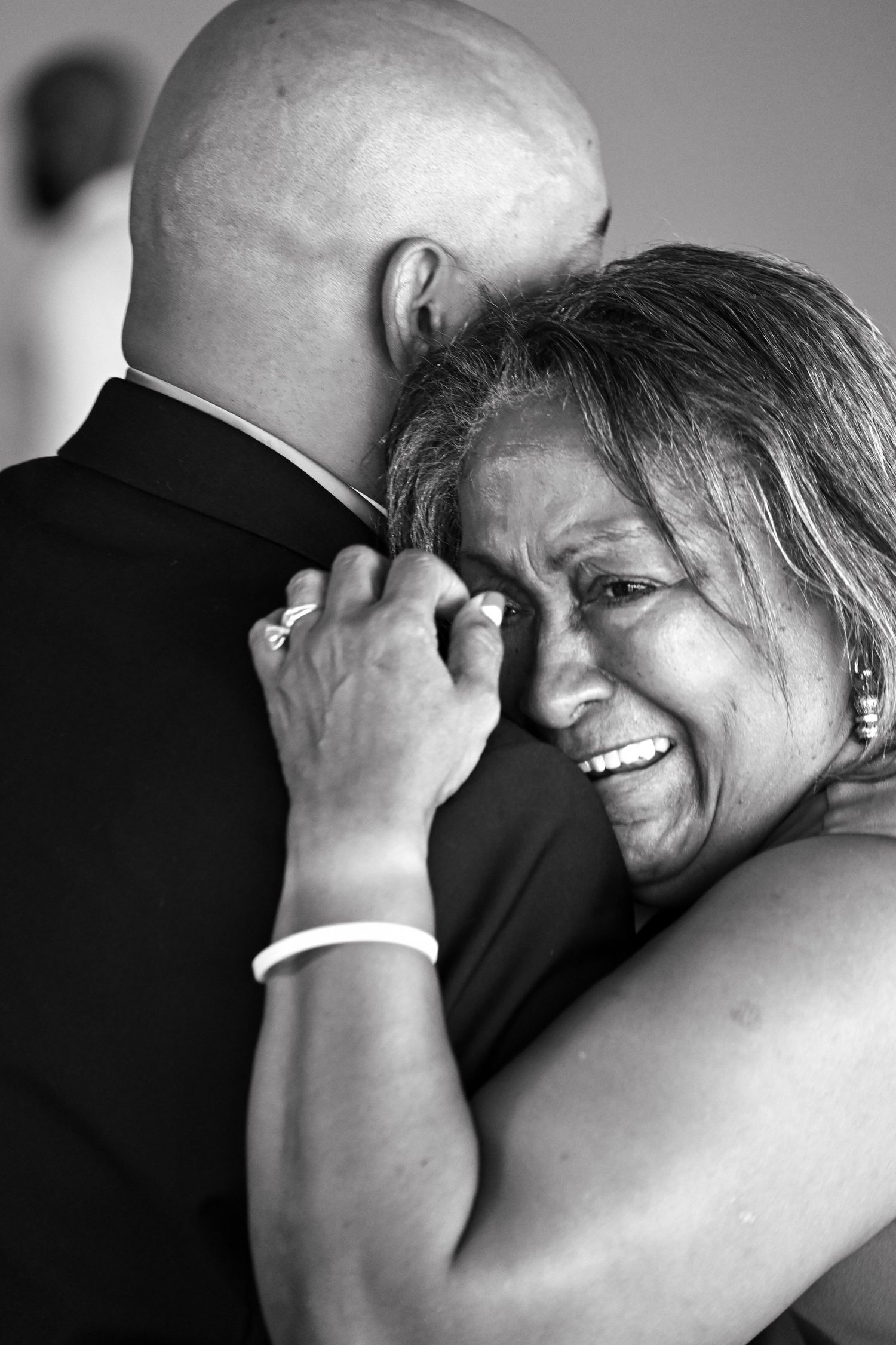 Black and white photo series capturing intimate emotional embraces during a special celebration.