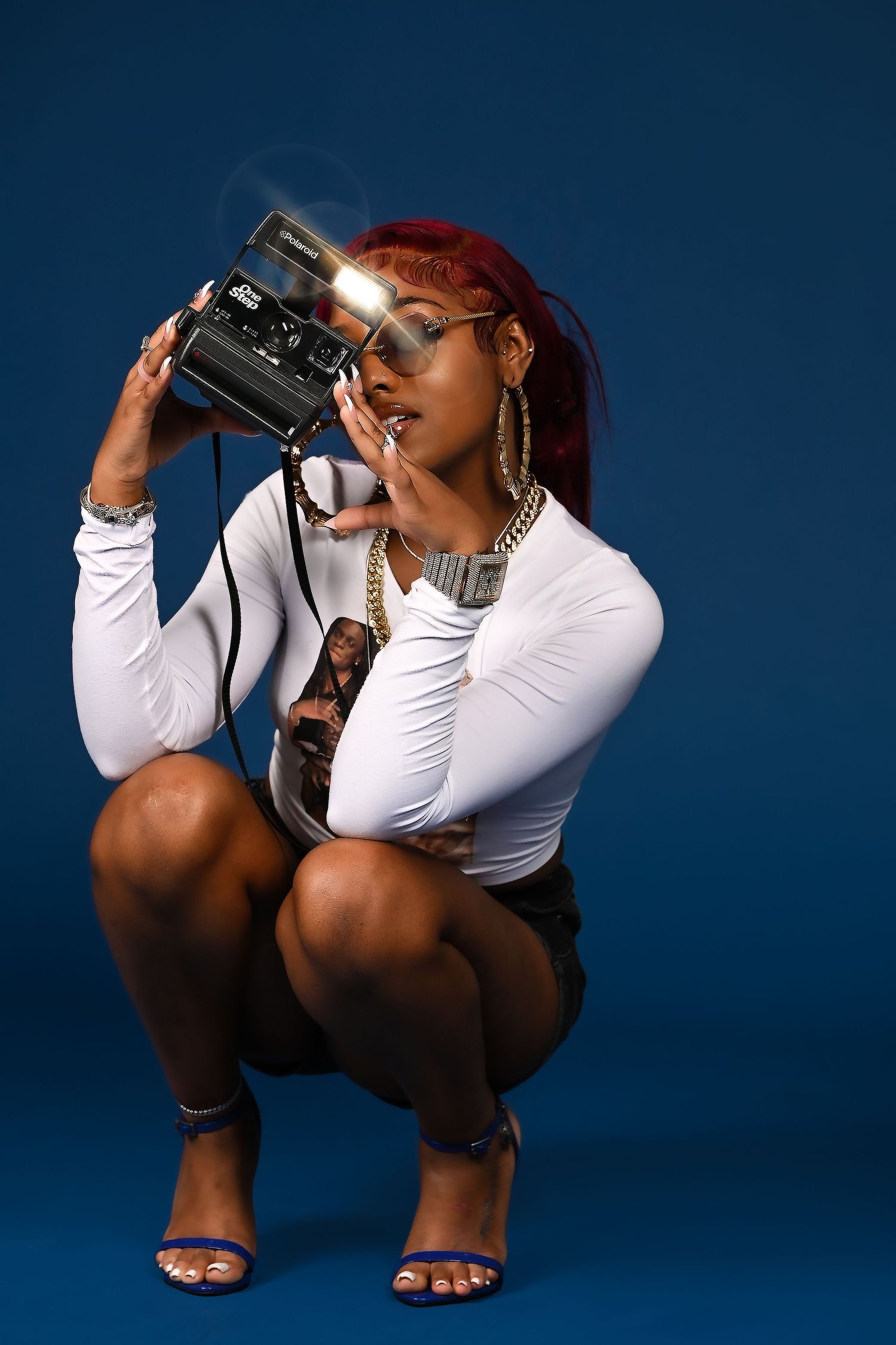Creative portrait series with binoculars against deep blue studio background. In Tampa Florida.