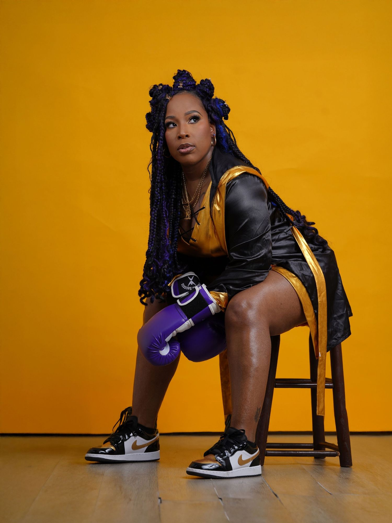 Athletic fashion portrait with braided hair against vibrant yellow background in Saint Petersburg Florida.