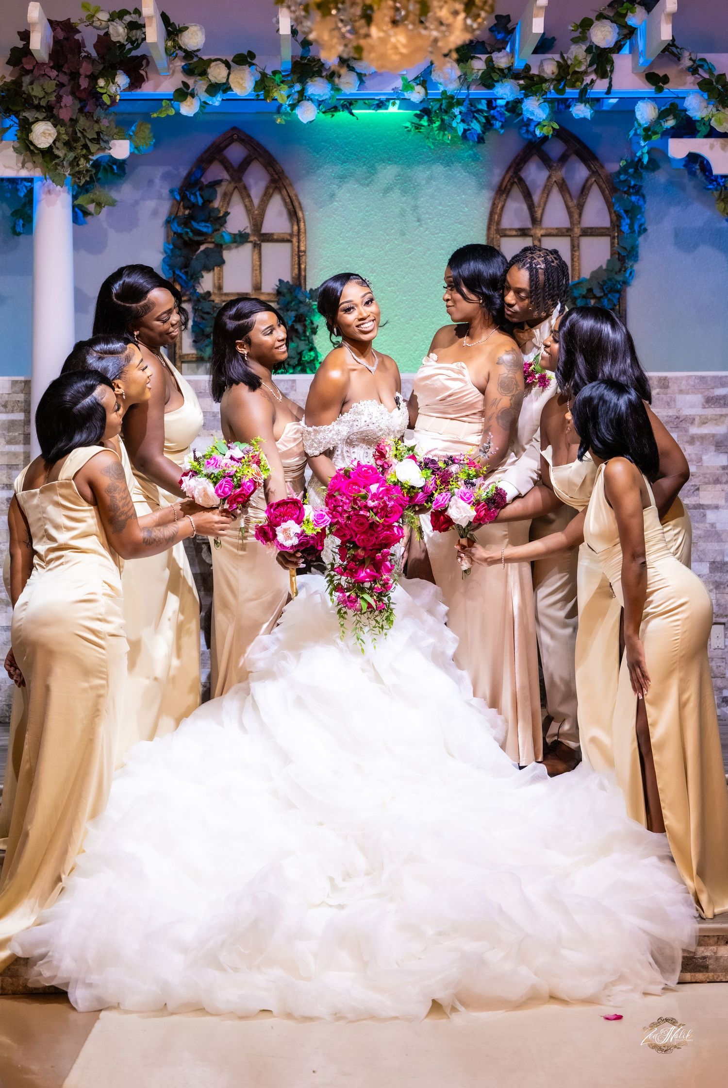 Joyful bridal party in champagne dresses celebrating with the bride in a white gown.