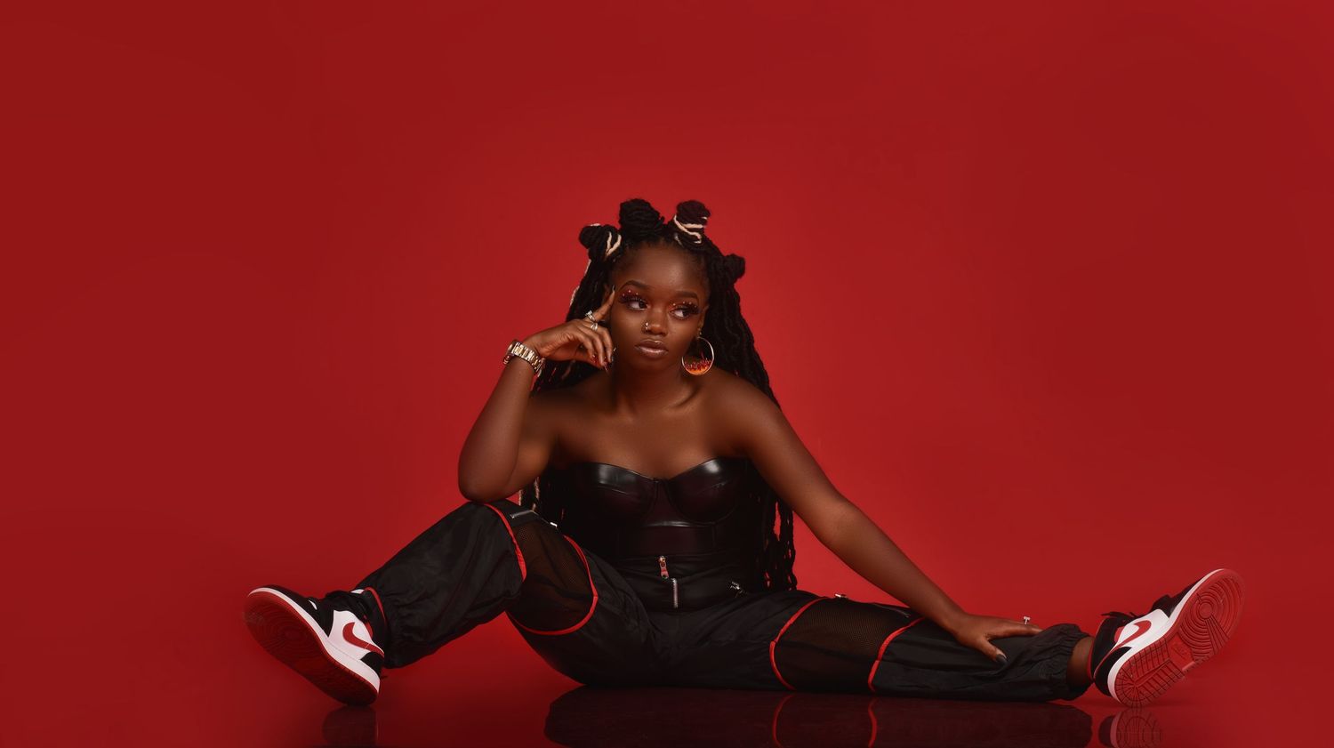 Dramatic fashion poses against vibrant red background in studio setting in Saint Petersburg Florida.