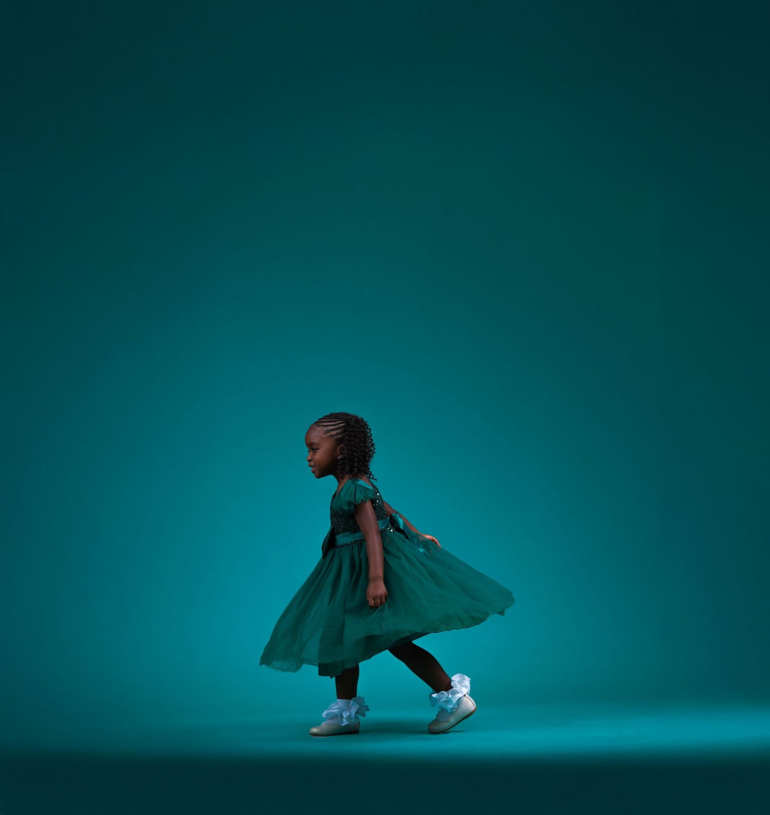Dynamic dance sequence in teal lighting showing flowing fabric movement in Saint Petersburg Florida.