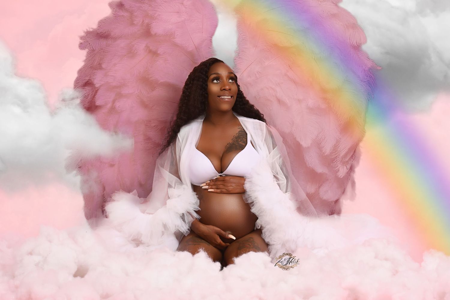 Dreamy maternity photo with pink smoke effects and rainbow overlay.