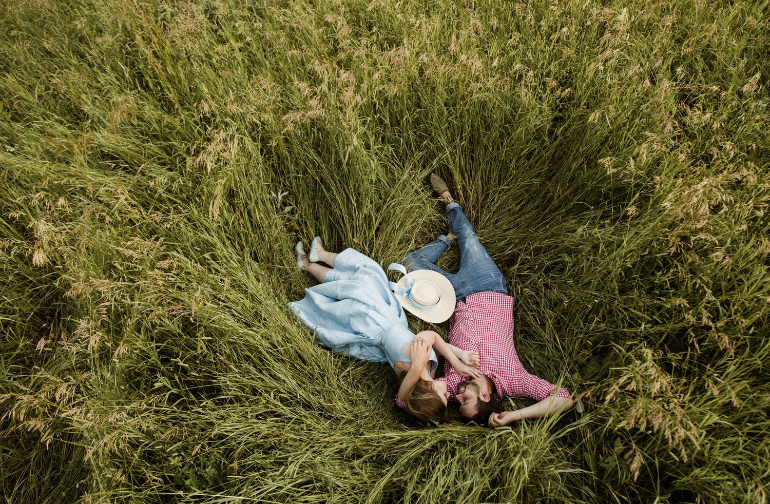 A sequence of photos showing someone lying in tall green grass and rolling down a grassy hillside.