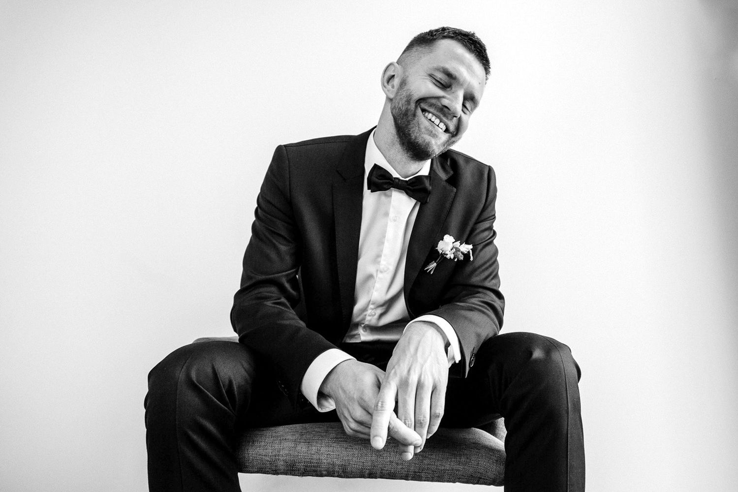A black and white photo sequence showing someone in a tuxedo laughing and gesturing expressively.