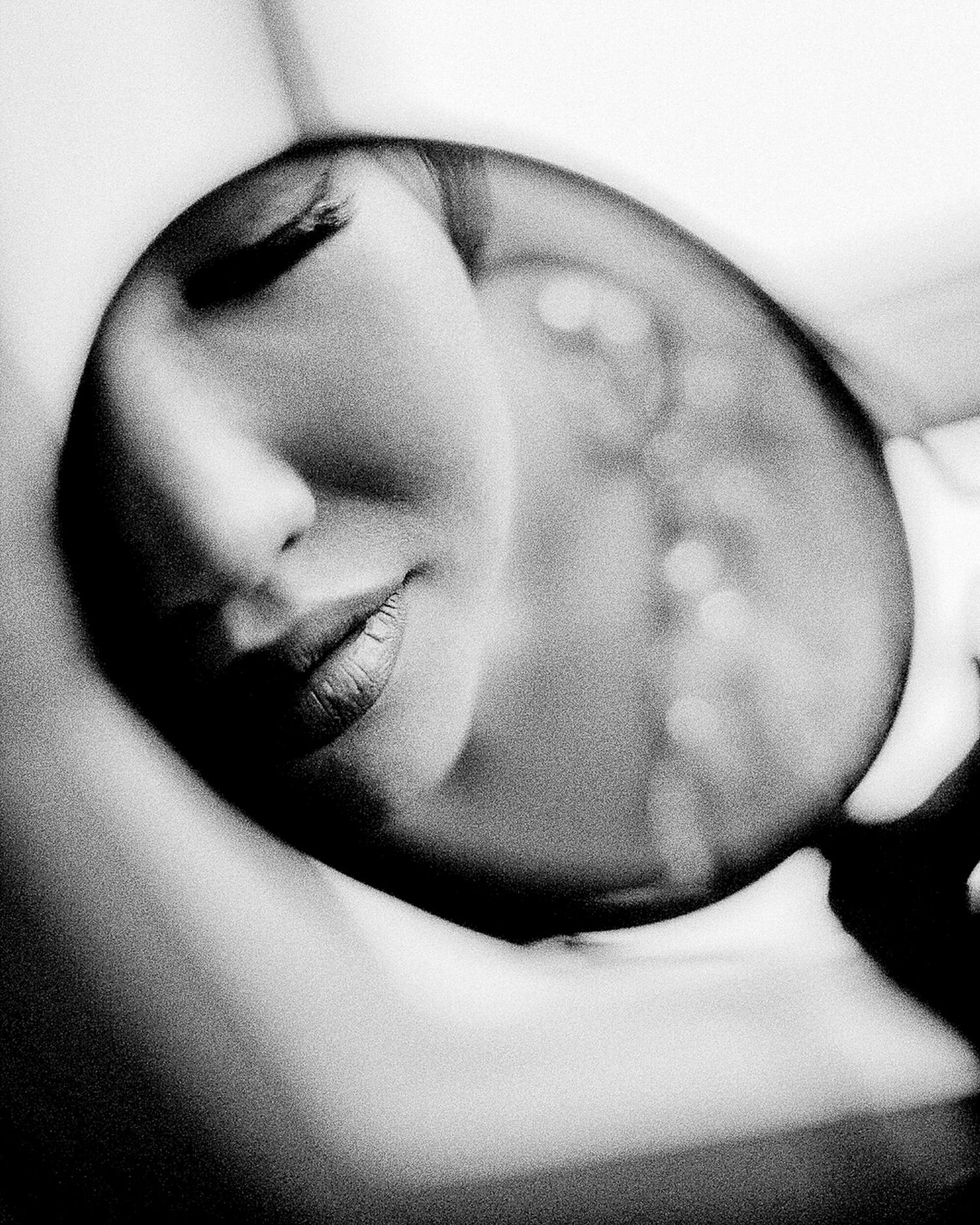 Artistic black and white portrait series showing close-up views of a face in different angles and expressions.