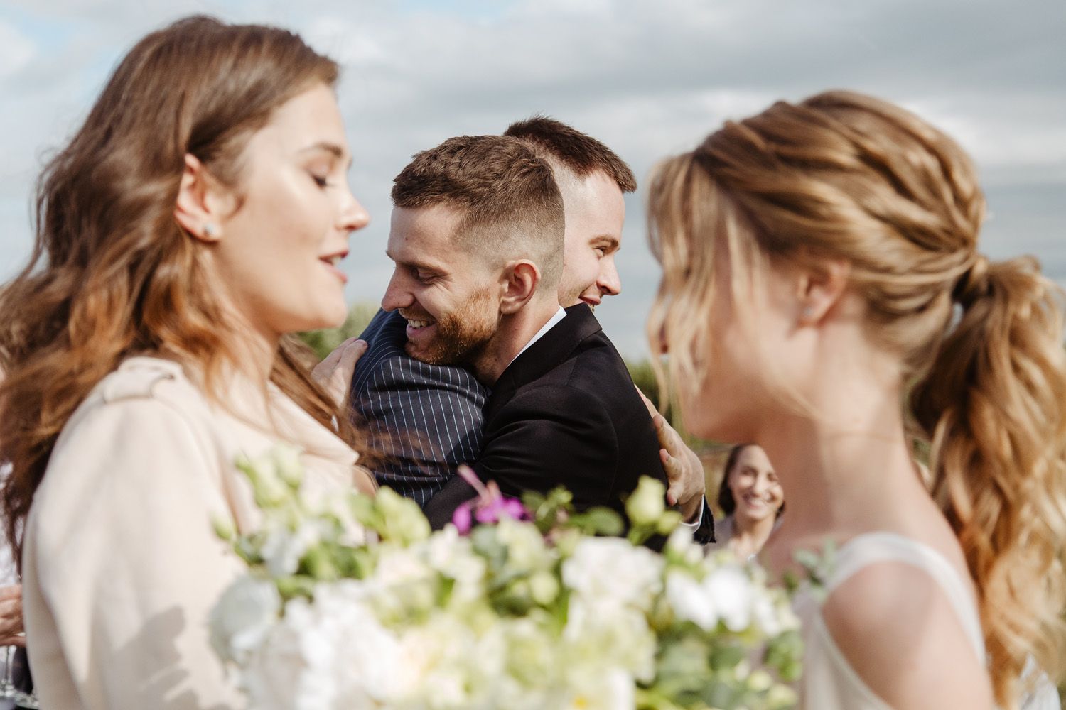 Candid moments from an outdoor wedding ceremony with floral decorations.