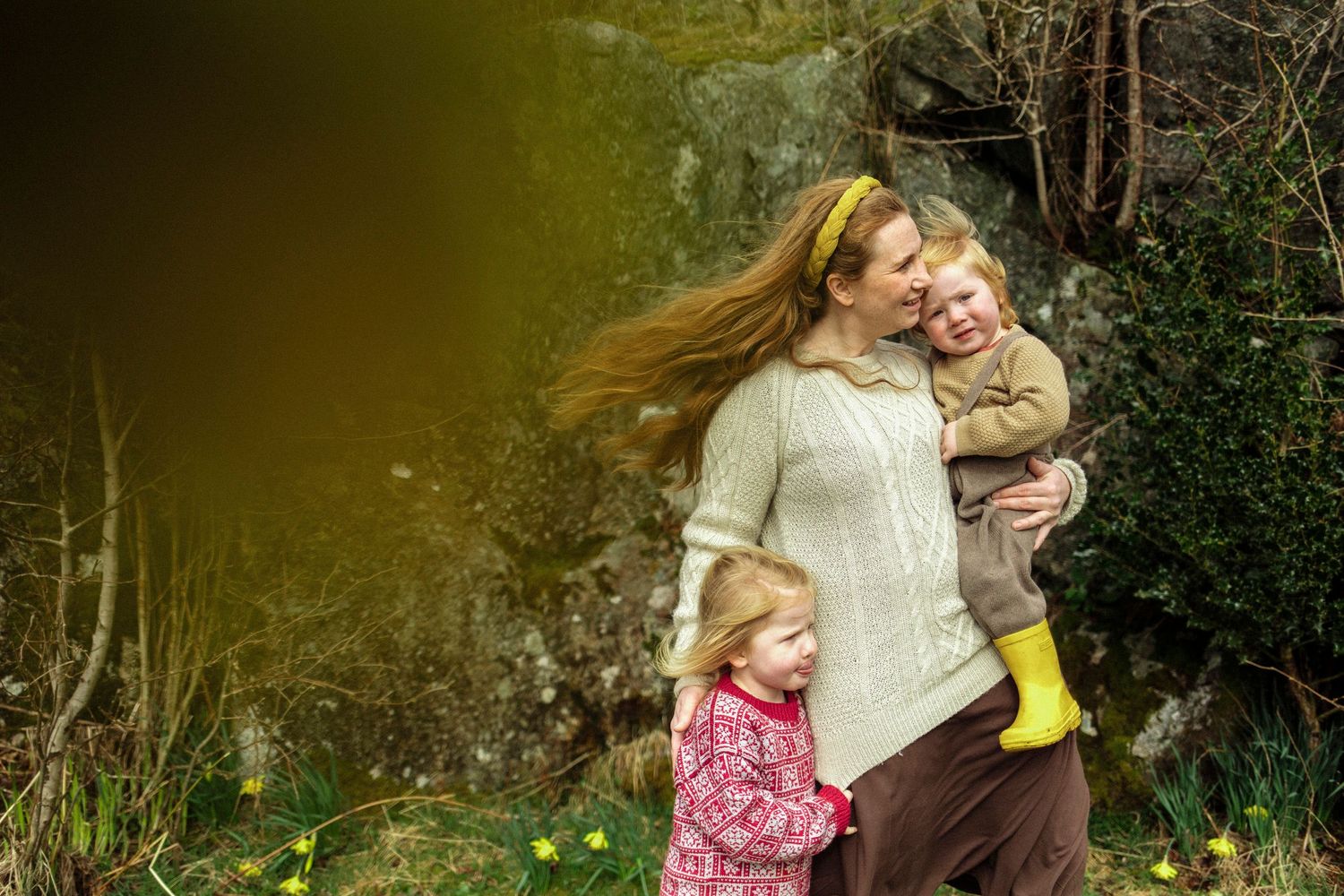 A joyful outdoor moment in nature with yellow boots and cozy sweaters.