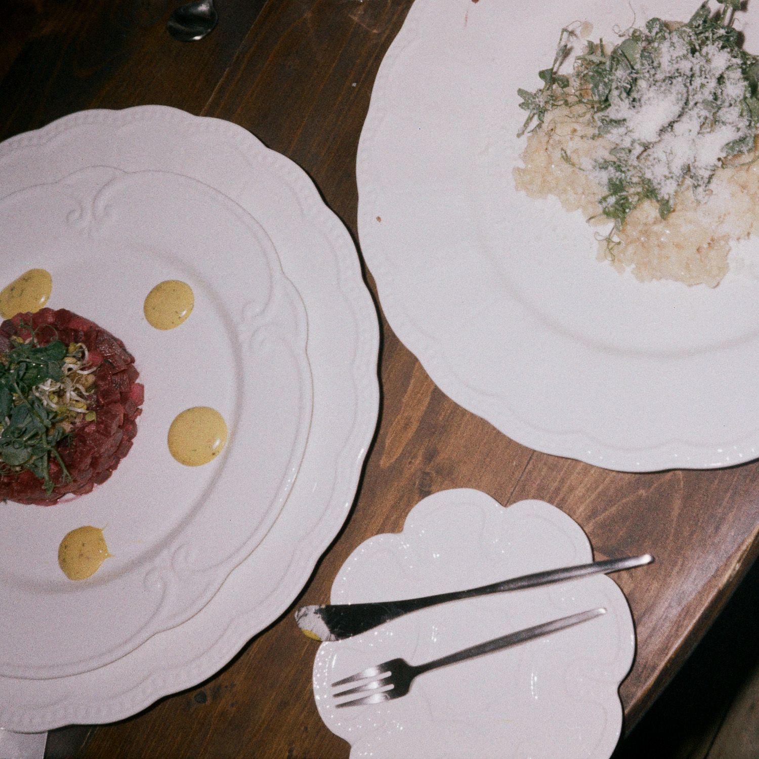Time-lapse sequence of empty white plates on wooden table showing gradual disappearance of food.