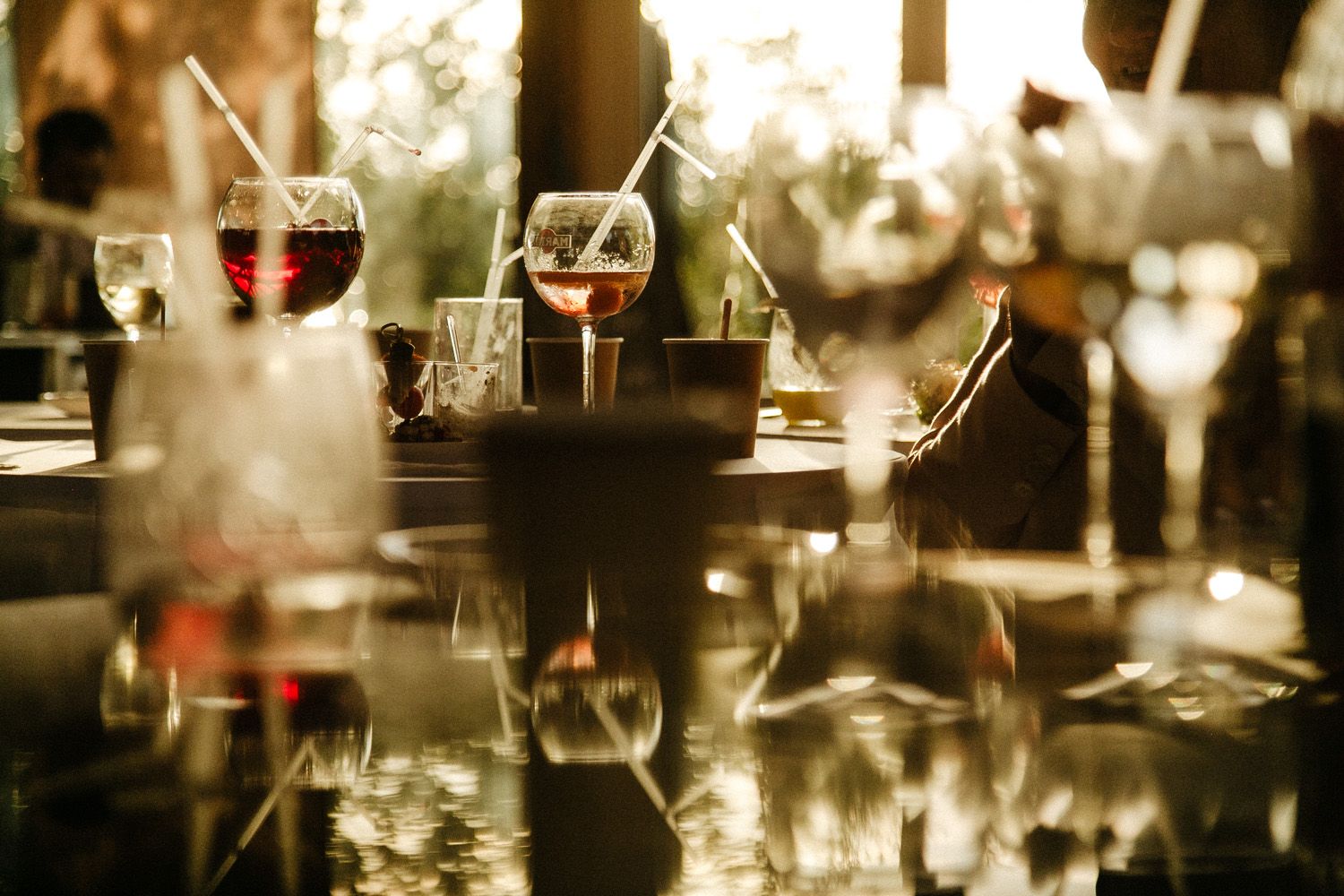 Abstract blurred wedding reception scene with soft warm lighting and bokeh effects.