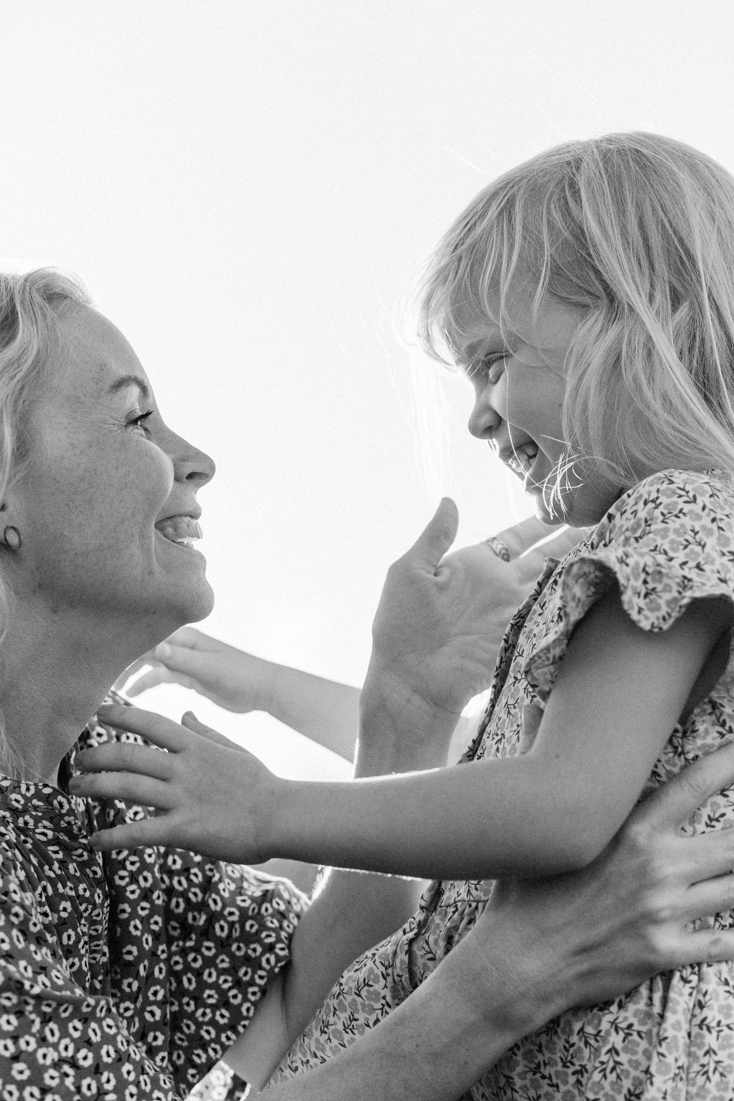 Black and white portrait series showing tender moments between two people embracing with joyful expressions.