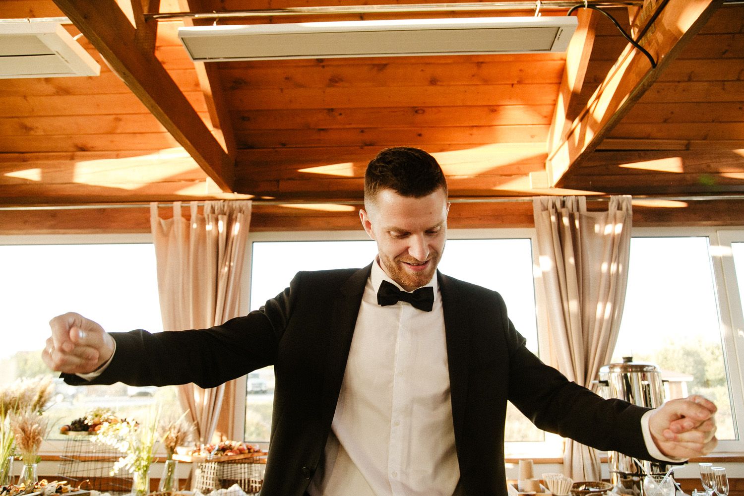 Wedding servers in formal attire prepare to serve at an elegant reception.