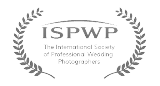 Three circular wreath-style awards or certification badges from The International Society of Professional Wedding Photographers.