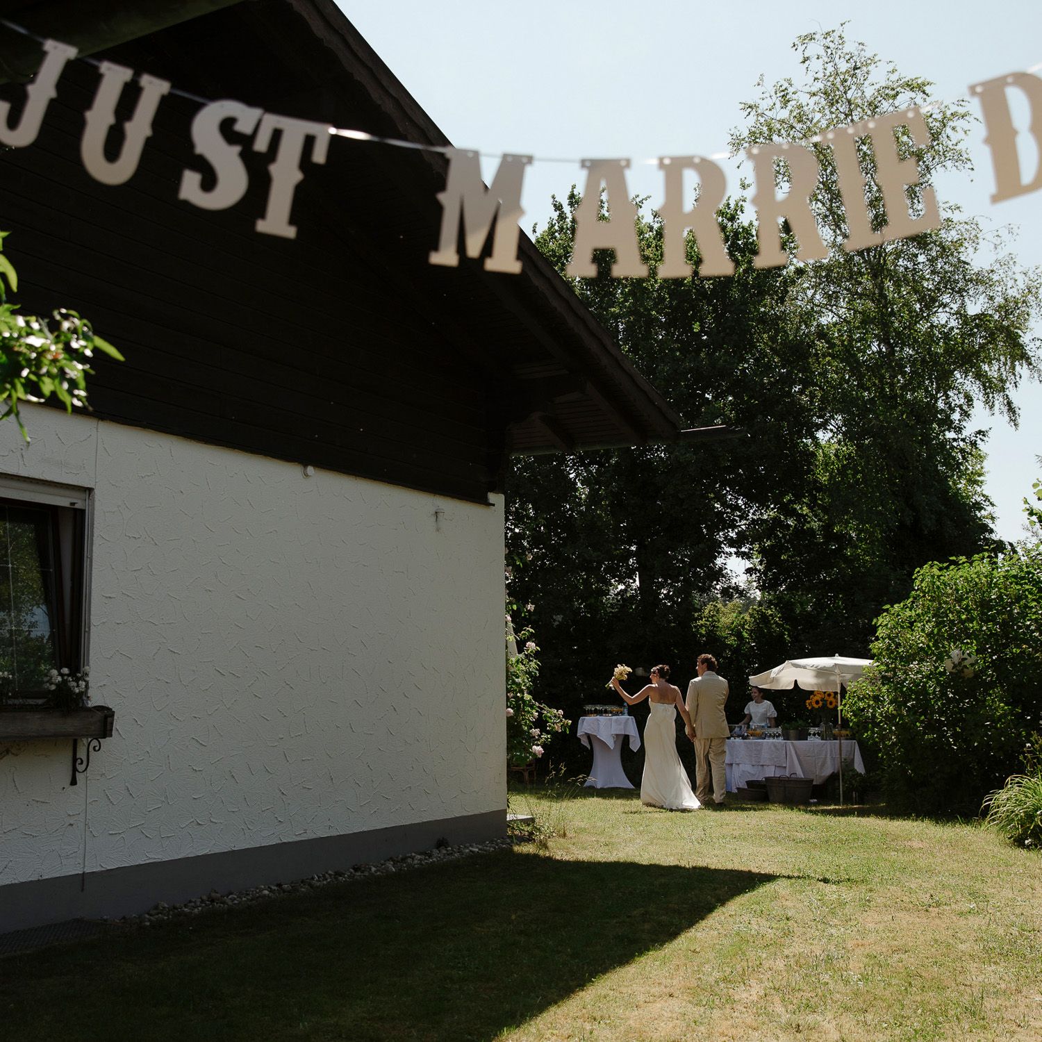 Historic white building with 'Post Market' signage visible against a sunny blue sky and green trees.