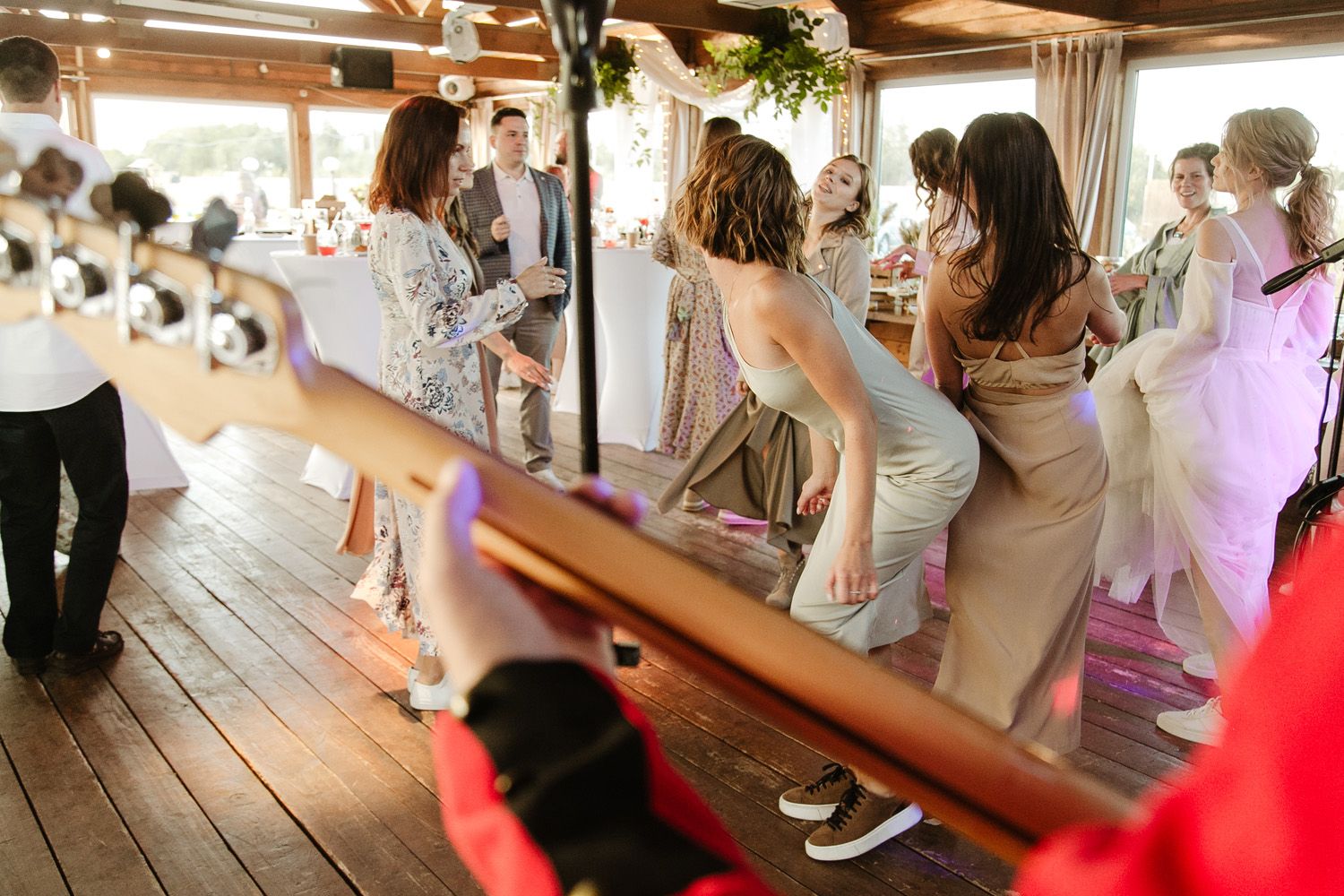 Wedding party lines up on a rustic wooden deck in a fun dance formation.