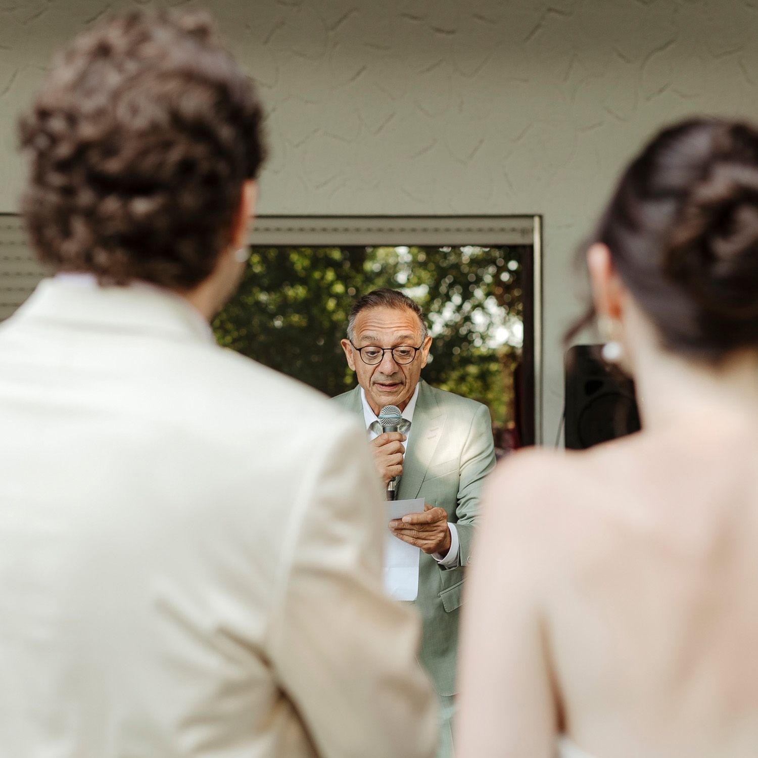 People gathered indoors at a social event with soft lighting and blurred background.