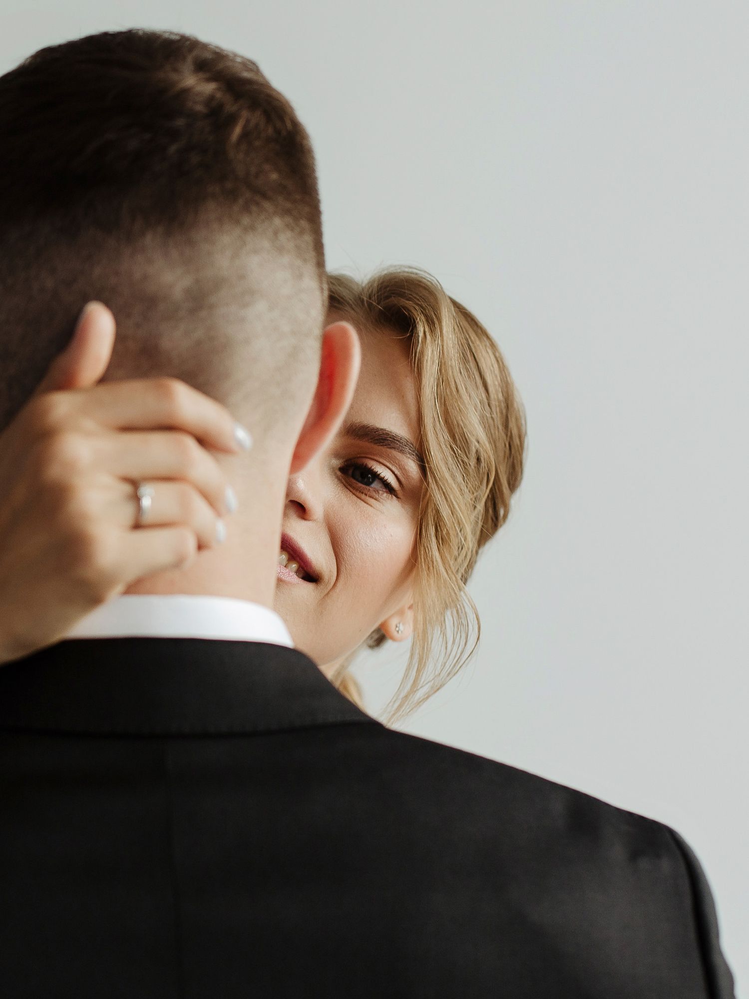 Intimate black and white photo sequence capturing romantic moments between a couple against a light background.