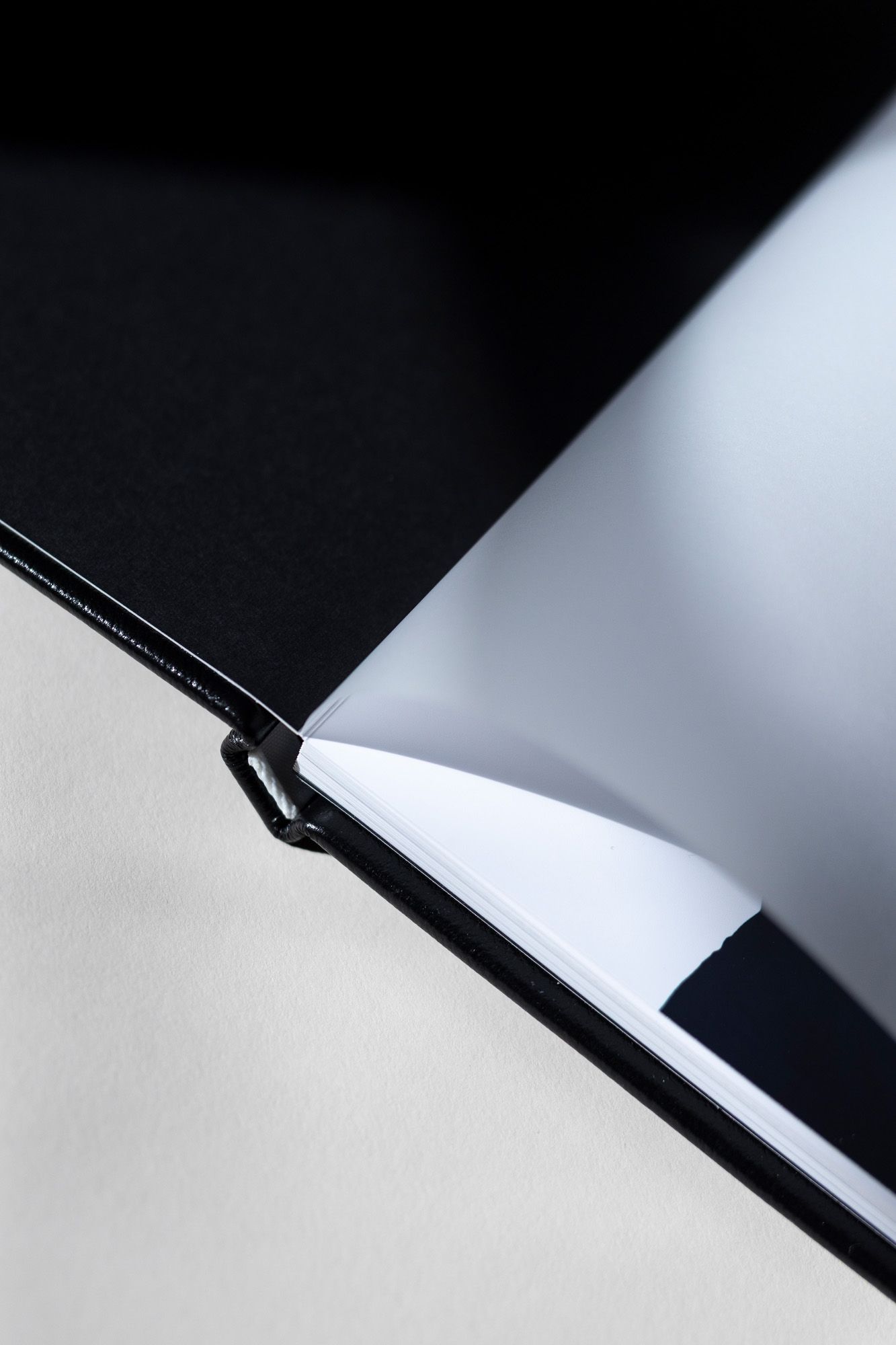 Abstract black and white composition with diagonal lines and shadows creating a minimalist geometric pattern.