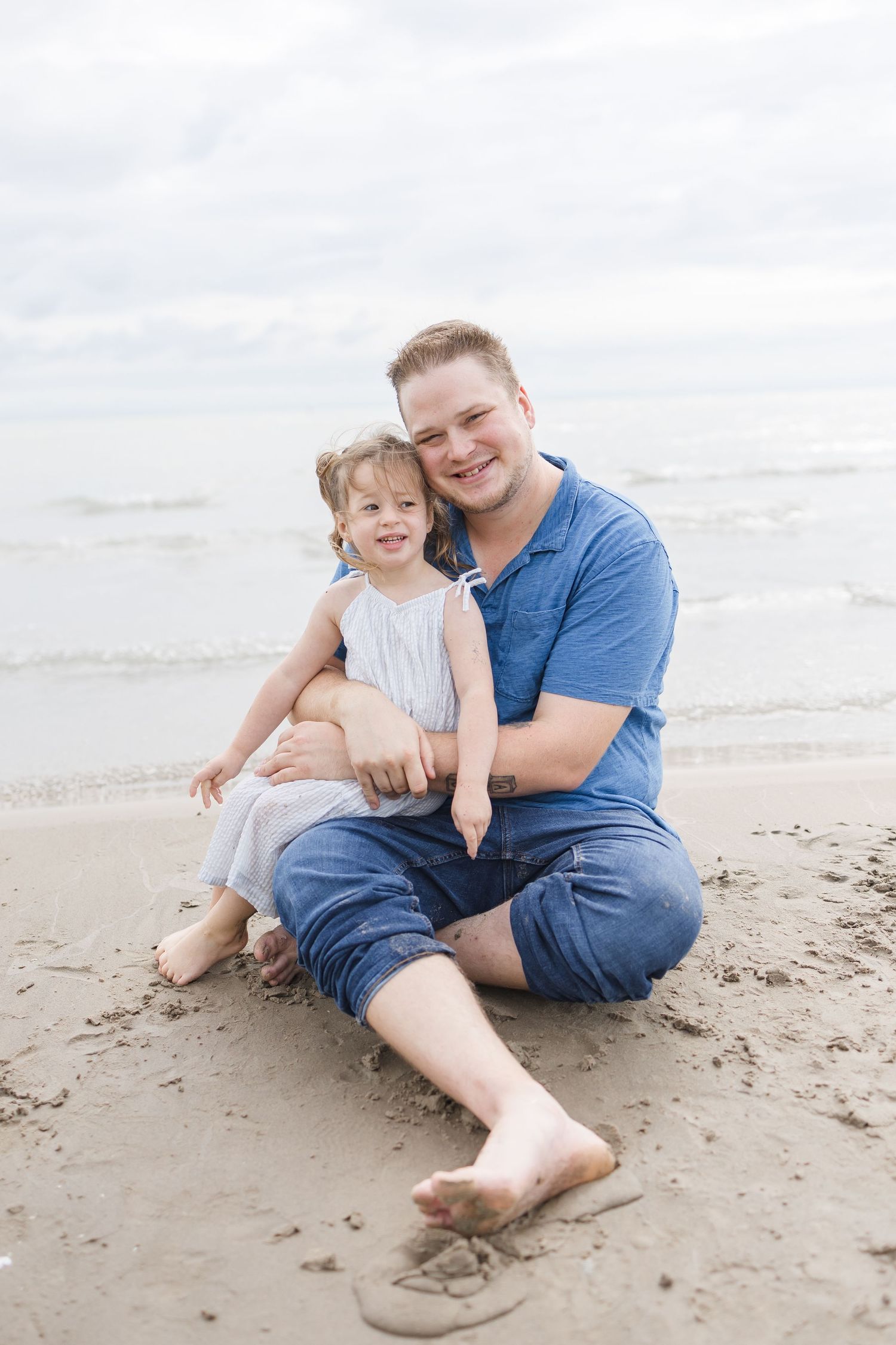 Family enjoying quality time together while sitting on the beach shore.