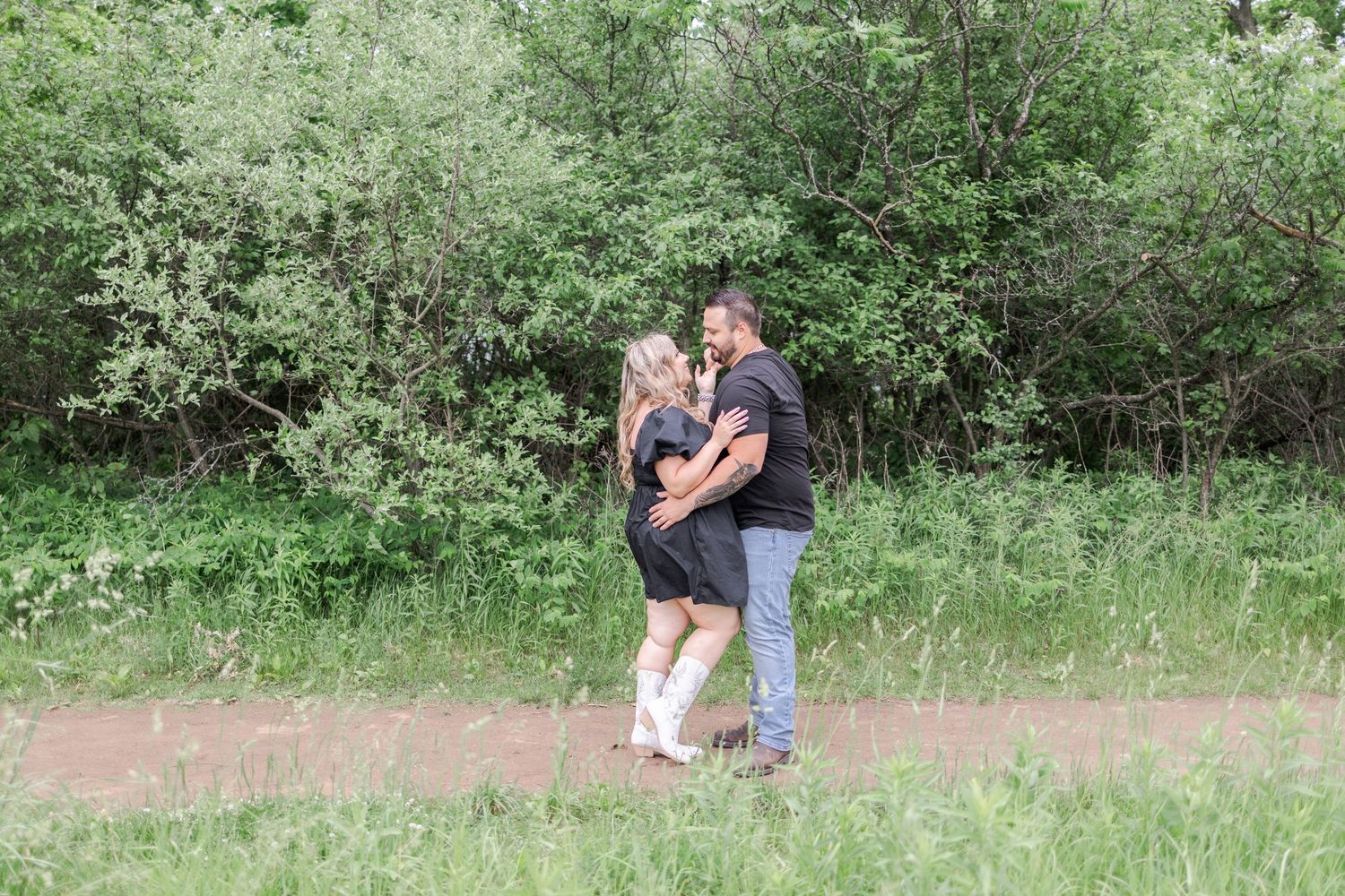 Natural outdoor setting with dirt path winding through green vegetation.