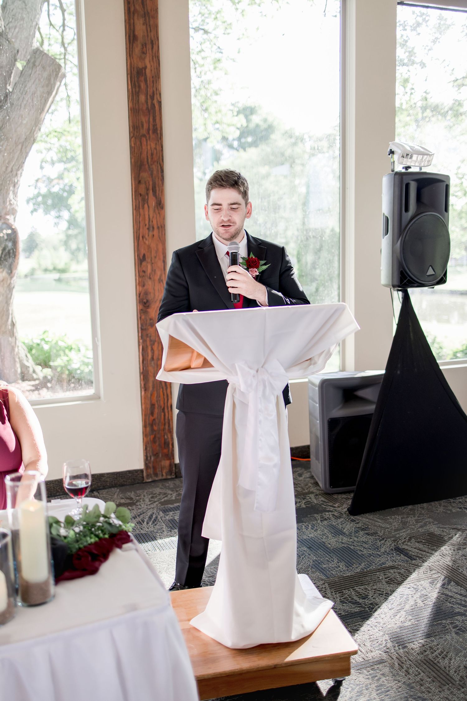 Wedding reception candid moments with couple and guests in bright venue space.
