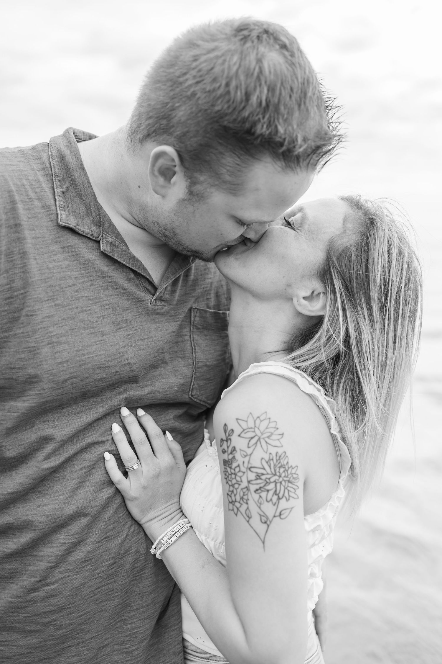 Romantic black and white close-up of a couple sharing an intimate moment.