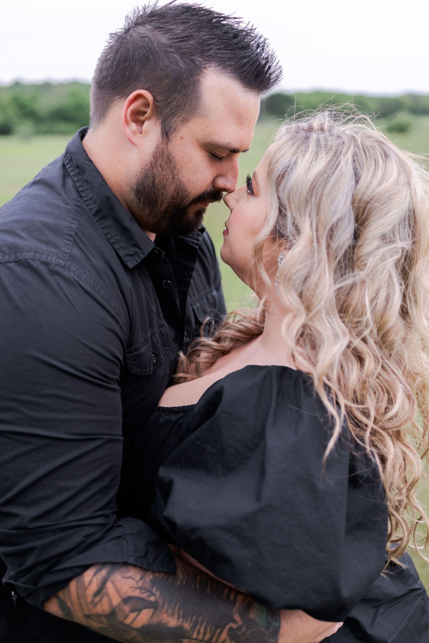 A series of romantic black and white photos showing a couple's intimate moments outdoors.