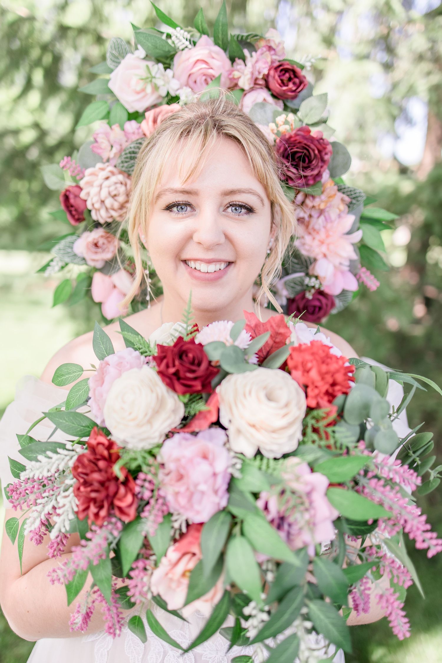 Beautiful wedding bouquet featuring pink and burgundy roses with greenery.