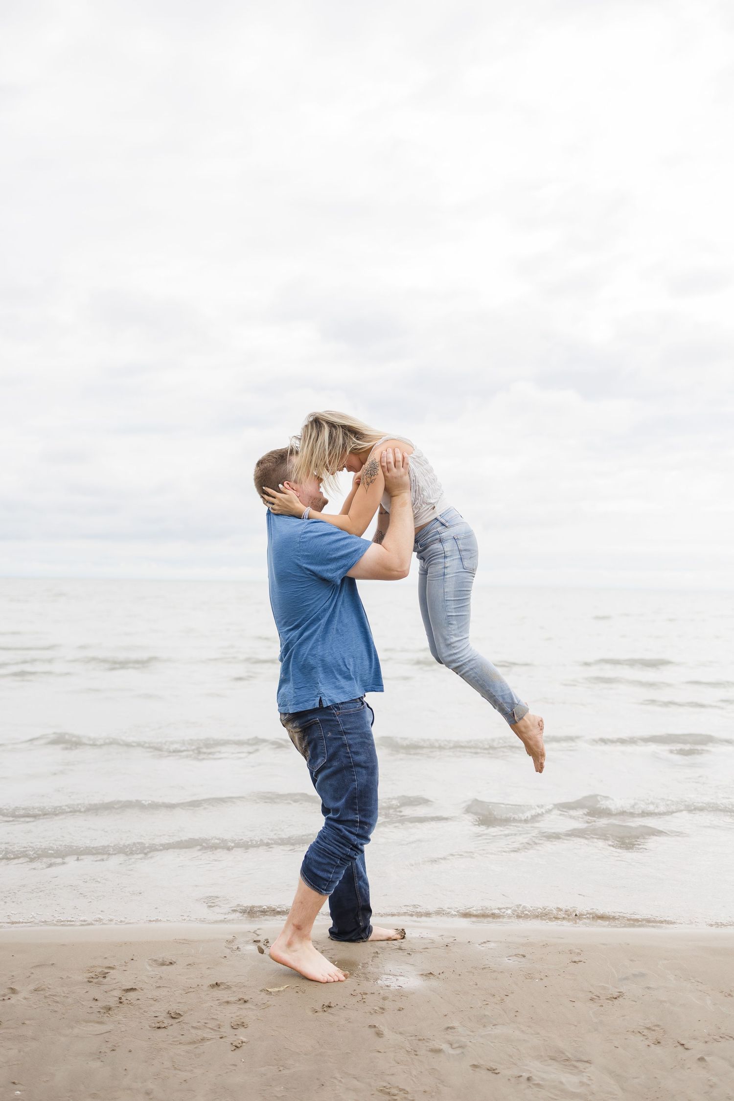 Playful moments captured of a couple having fun at the beach.