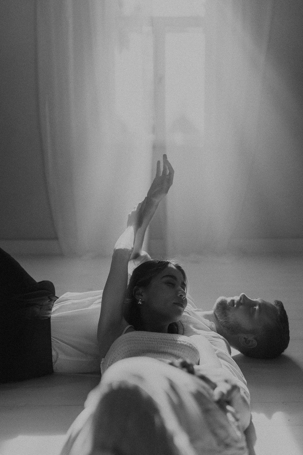 A black and white photo sequence shows person laying back and stretching while on the floor.