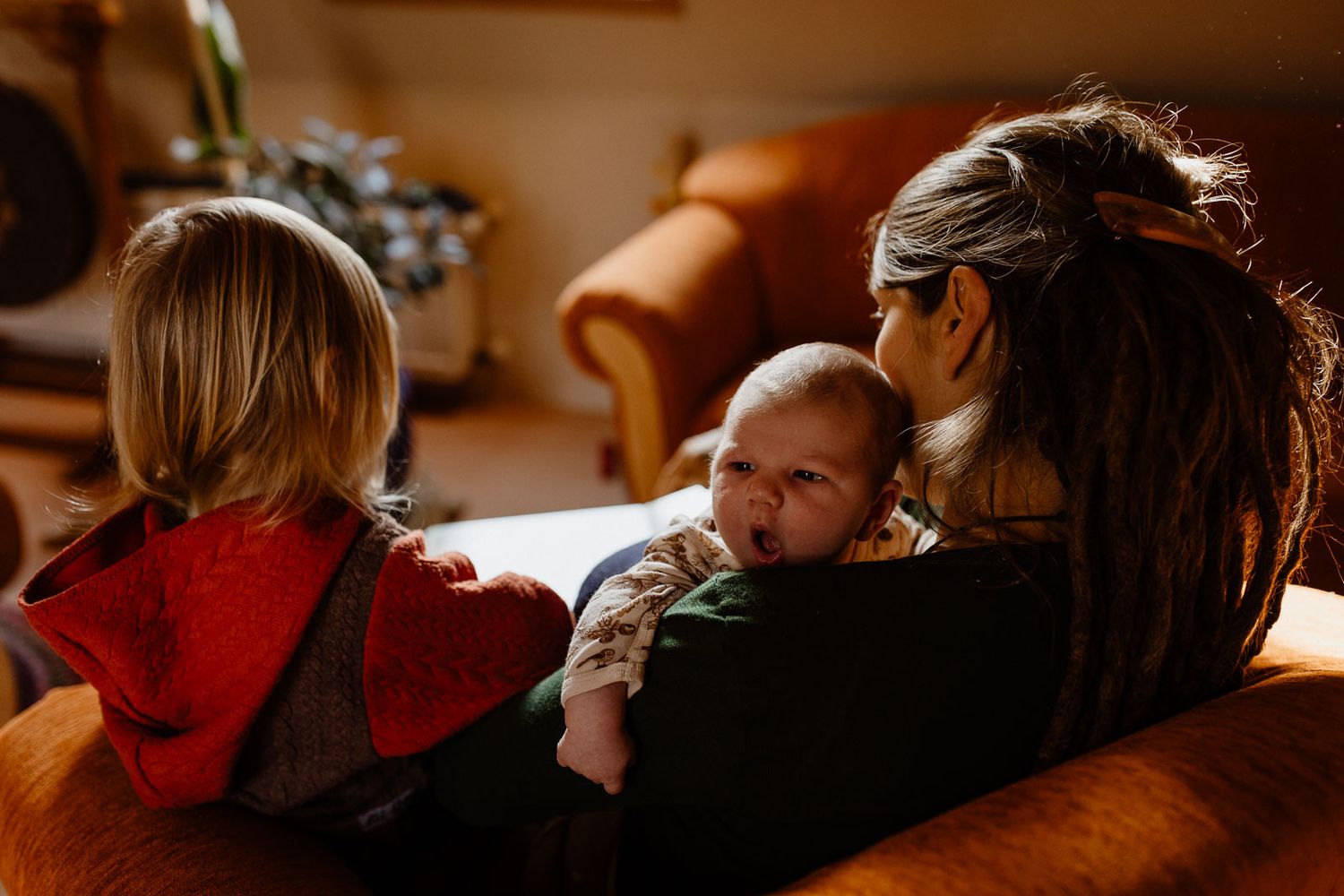 A cozy family moment on the sofa in warm afternoon light.