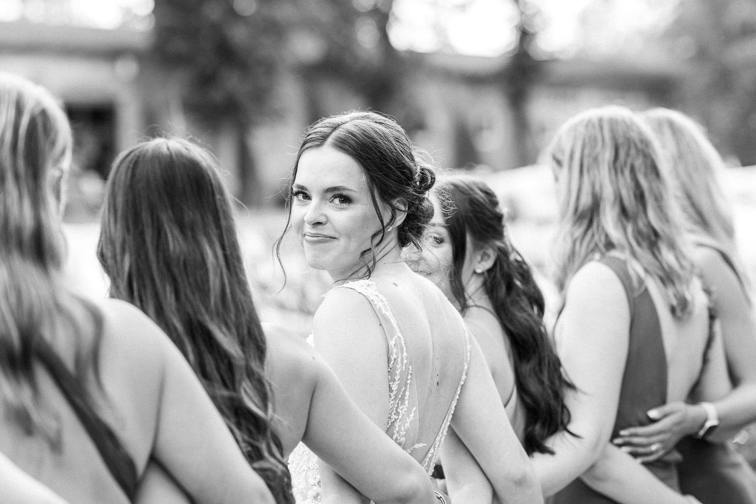 Wedding celebration gathering with guests in formal attire outdoors.