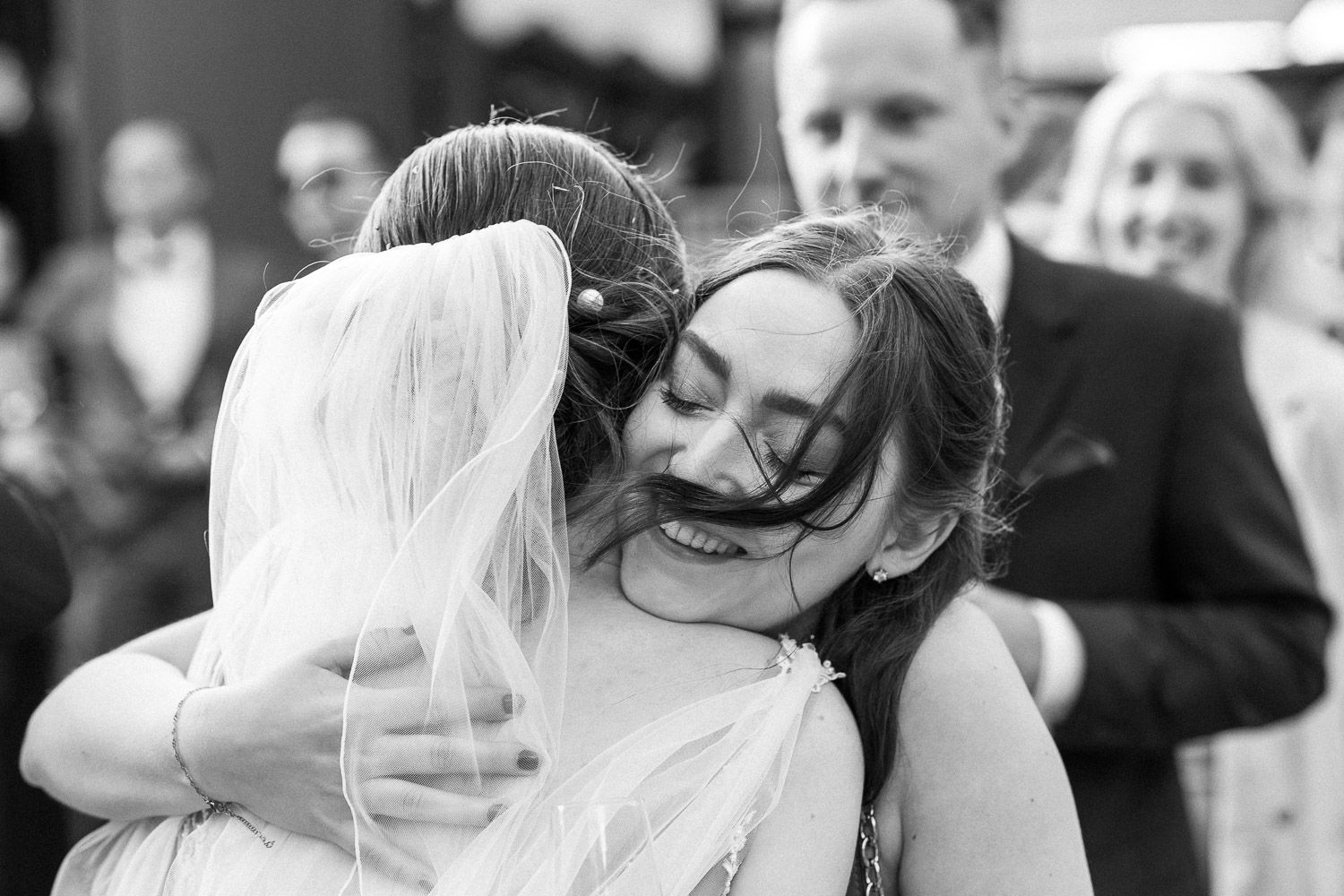 An emotional embrace shared during a wedding celebration.