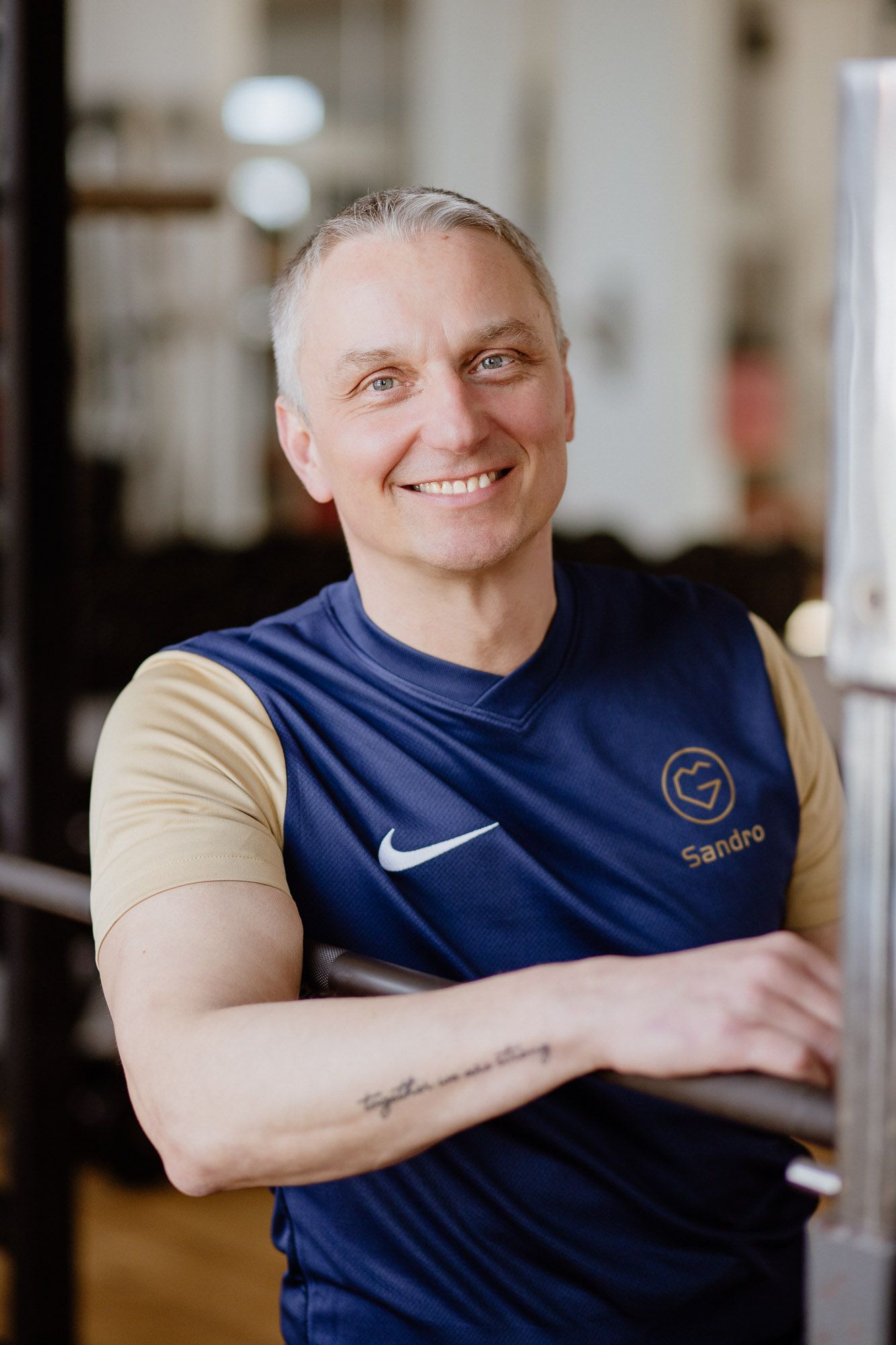 Person in a navy blue athletic shirt and beige sleeves shown from different angles.
