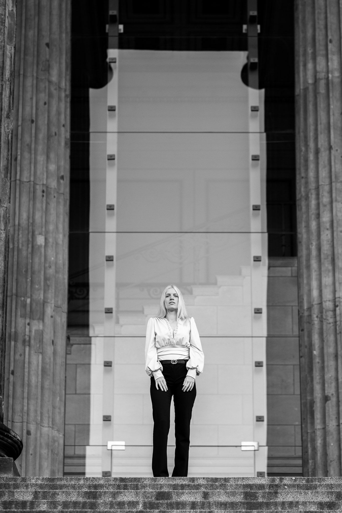Black and white architectural photo showing column pillars against a light background.
