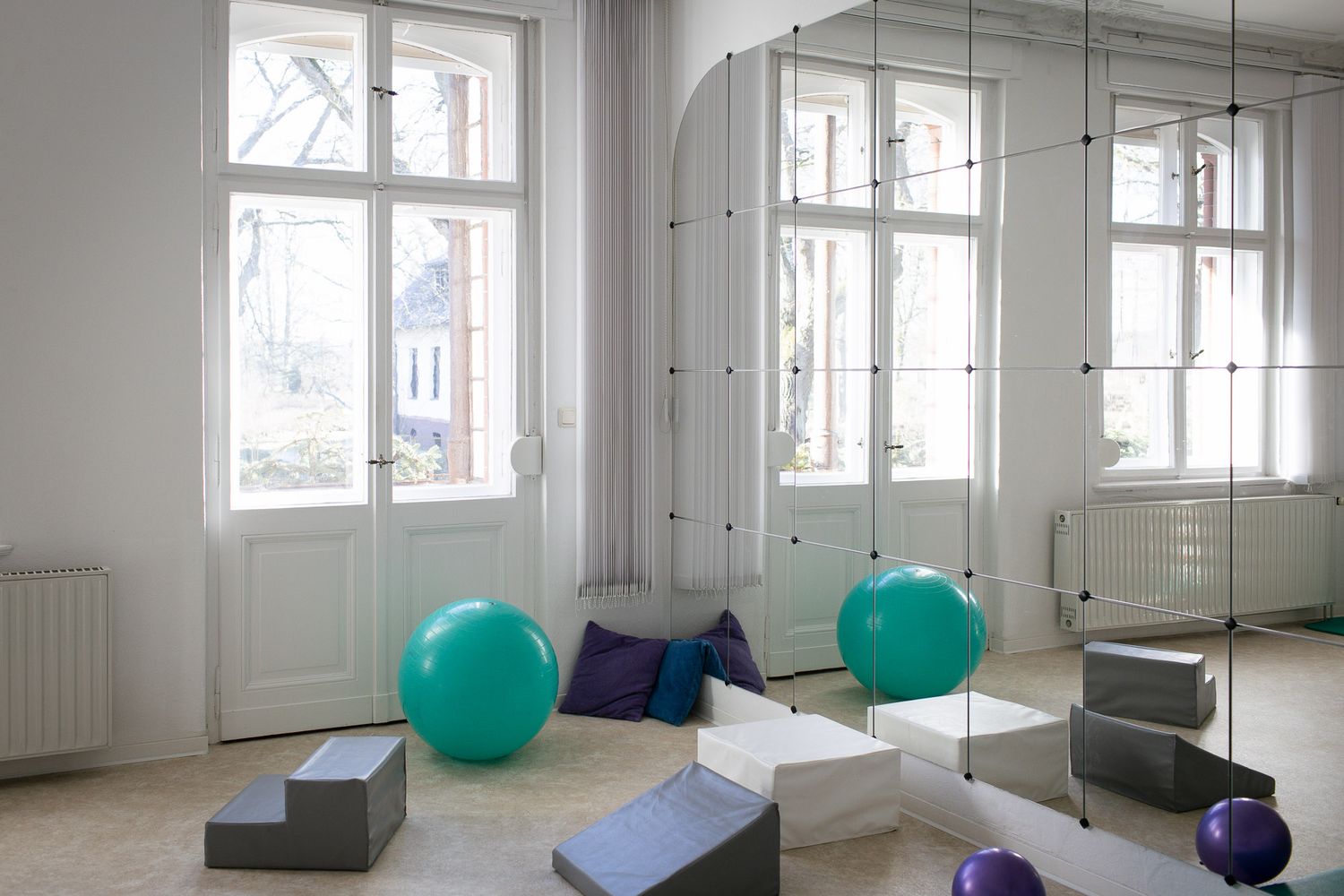 Bright modern studio space with exercise balls and natural lighting.