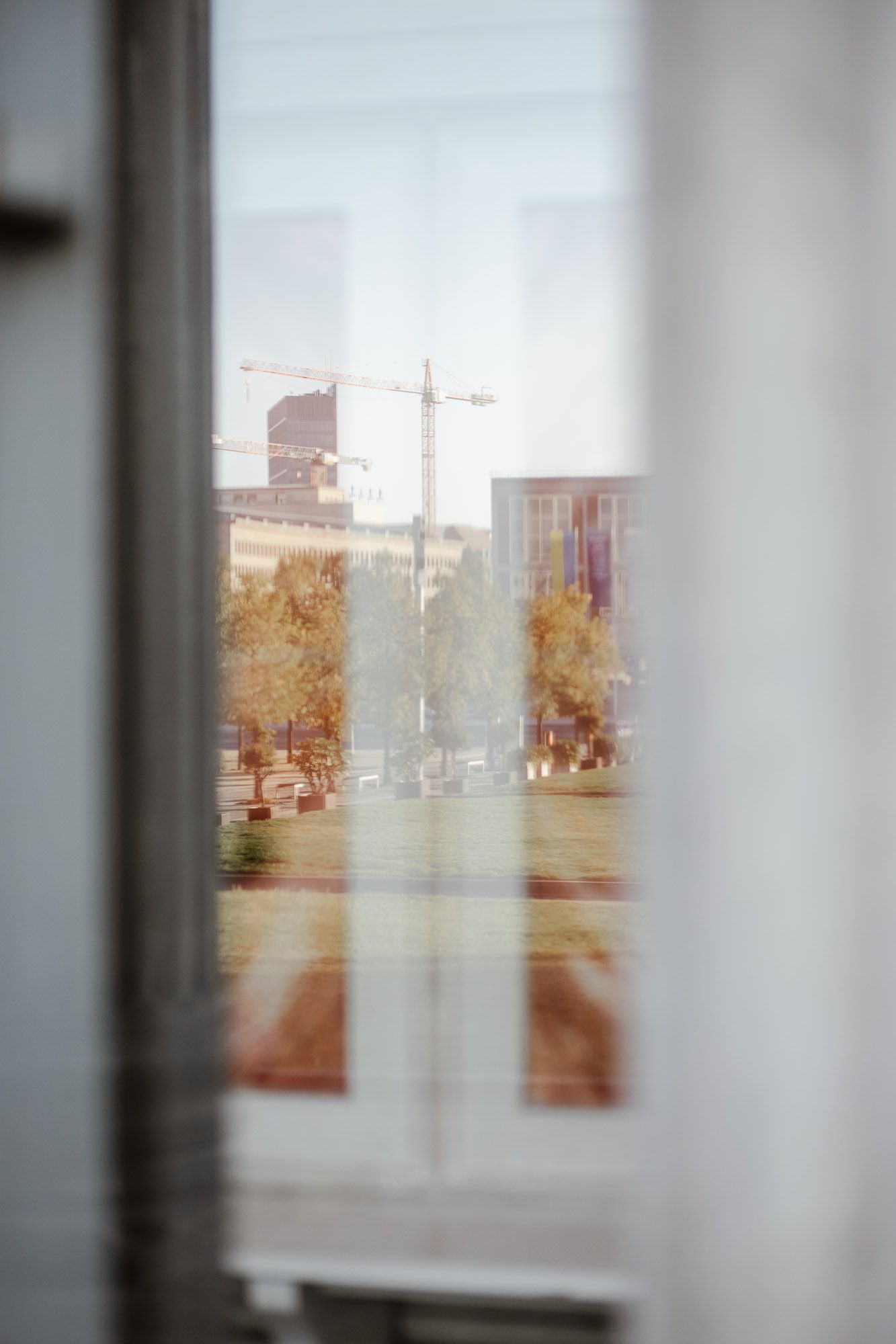 Blurred window view of cityscape with soft focus and muted tones.