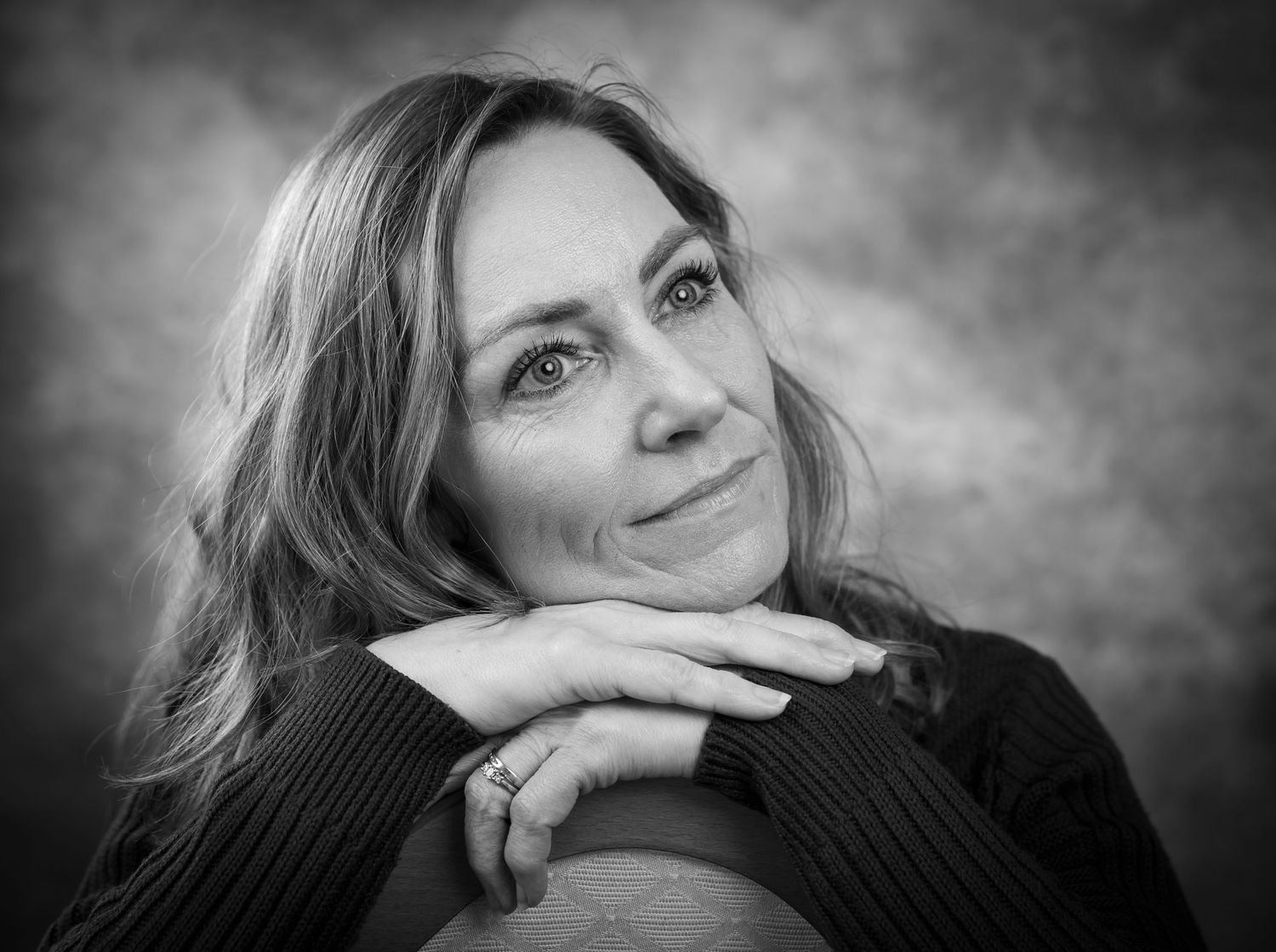 A series of black and white portraits showing different emotional expressions and poses in a dramatic lighting style.