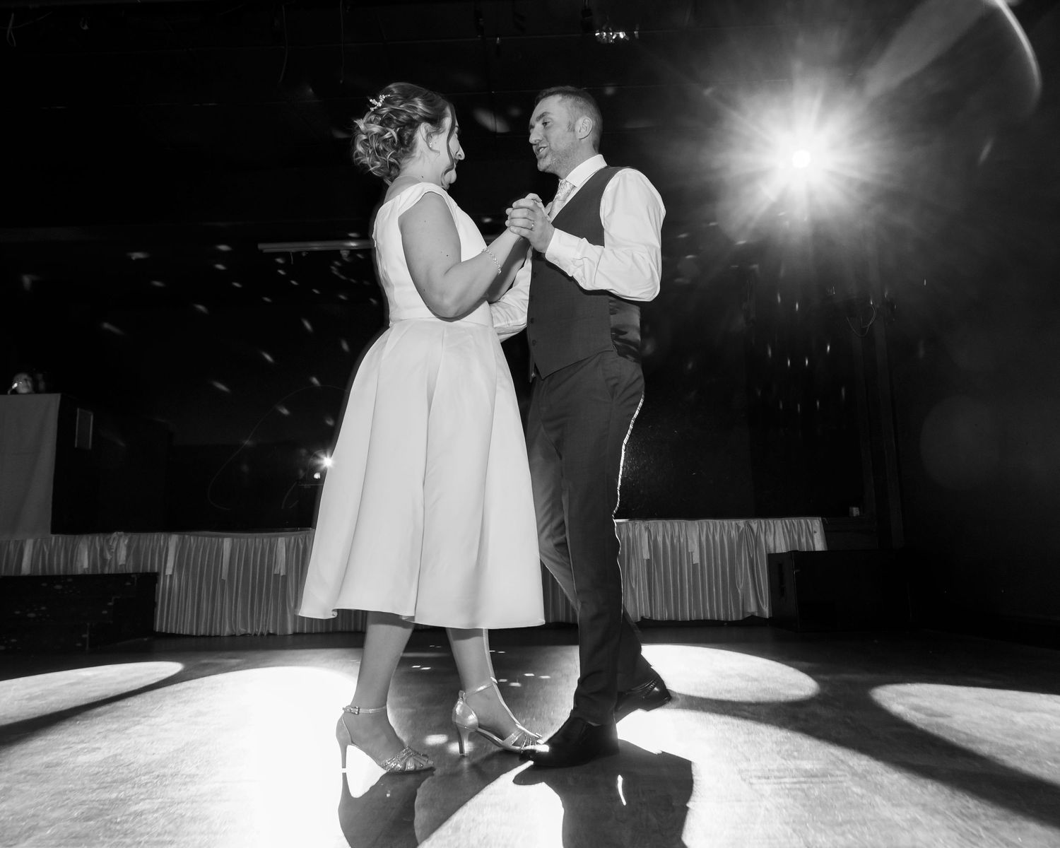 Black and white photos of couples dancing at an elegant wedding reception.